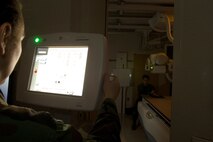 Tech. Sgt. Michelle Vanwinkle, a radiology technician, takes an X-Ray photograph of the hand of Airman 1st Class Jesse Lopez March 14. Sergeant Vanwinkle is assigned to the 5th Medical Support Squadron. (U.S. Air Force photo by Senior Airman Joe Rivera)