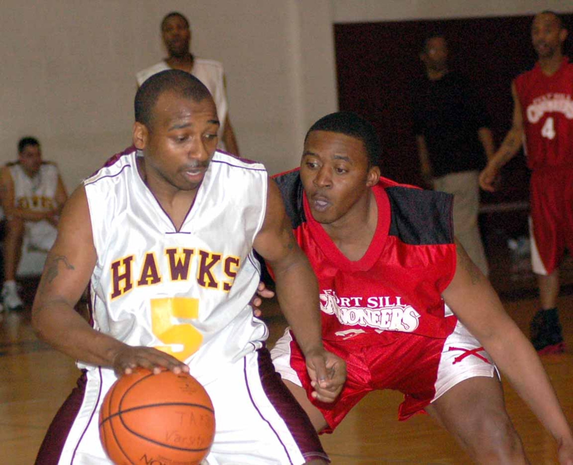 Tinker Hawks guard Ron Perry tires to dribble around Fort Sill guard Harold Hendersen during a March 15 game at the Gerrity Fitness and Sports Center. The Hawks won the game 87-74. (Air Force photo by John E. Banks)