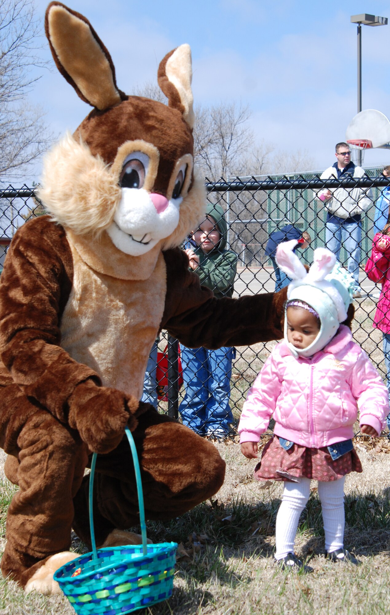 MCCONNELL AIR FORCE BASE, Kan.-- Jayla Reynolds, 1, daughter of Airman 1st Class Jeremy Reynolds, 22nd Services Squadron and wife Michelle, marvels at could be in the Easter bunny’s basket March 15, during an Easter egg hunt at the McConnell Southwind baseball fields. (Photo by Airman 1st Class Jessica Lockoski)