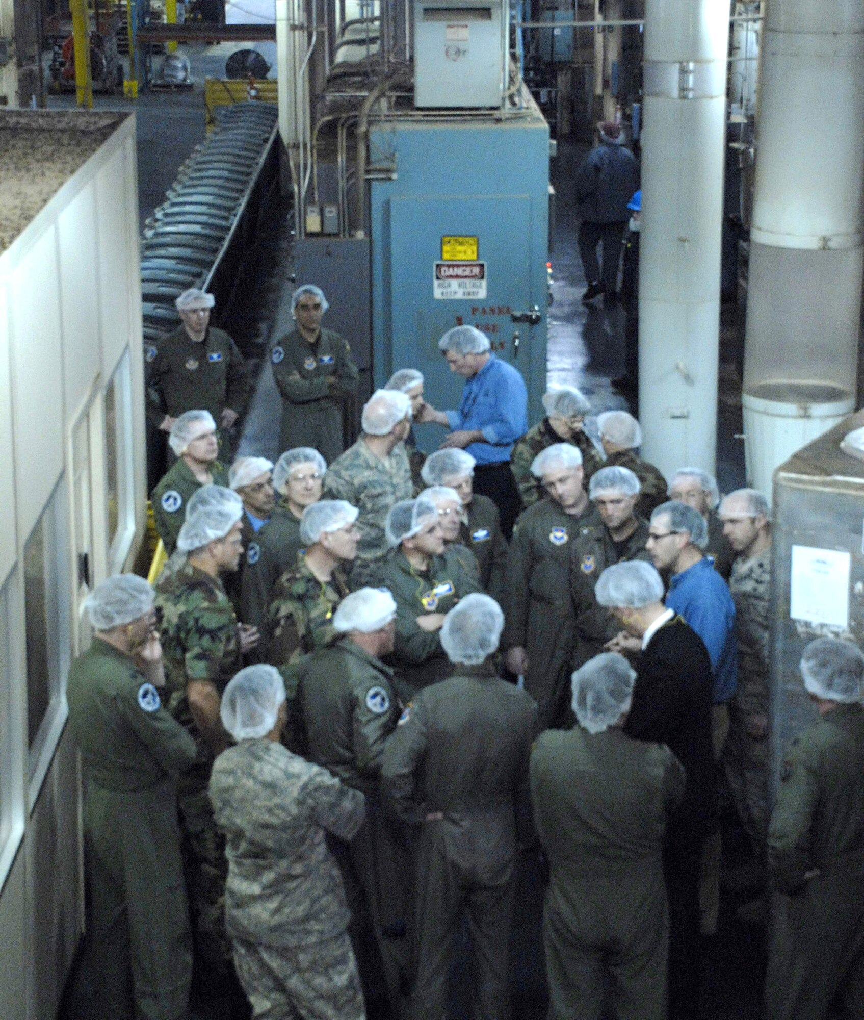 Two managers from the Eight O'Clock Coffee Company (blue shirts) speak with a group of Air Force officers and senior NCOs from the Pentagon during a tour of the company's production plant March 12 in Hyattsville, Md. The Airmen were there to gain insight as the company recently incorporated a program similar to Air Force Smart Operations for the 21st century into their work. (U.S. Air Force photo/Staff Sgt. Julie Weckerlein) 
