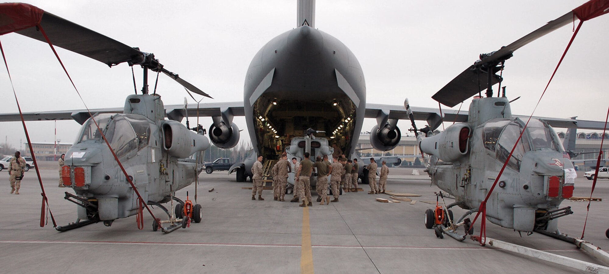 Marines with the 24th Marine Expeditionary Unit load three AH-1W Super Cobra helicopters onto an Air Force C-17 Globemaster III March 16 at Manas Air Base, Kyrgyzstan. The Marines are headed downrange to Afghanistan as part of the troop plus-up authorized by the president in January. The Marines will be a part of the NATO-International Security Assistance Force, conducting operations to extend the authority of the Government of the Islamic Republic of Afghanistan. (U.S. Air Force/Lt. Col. Adriane Craig) 