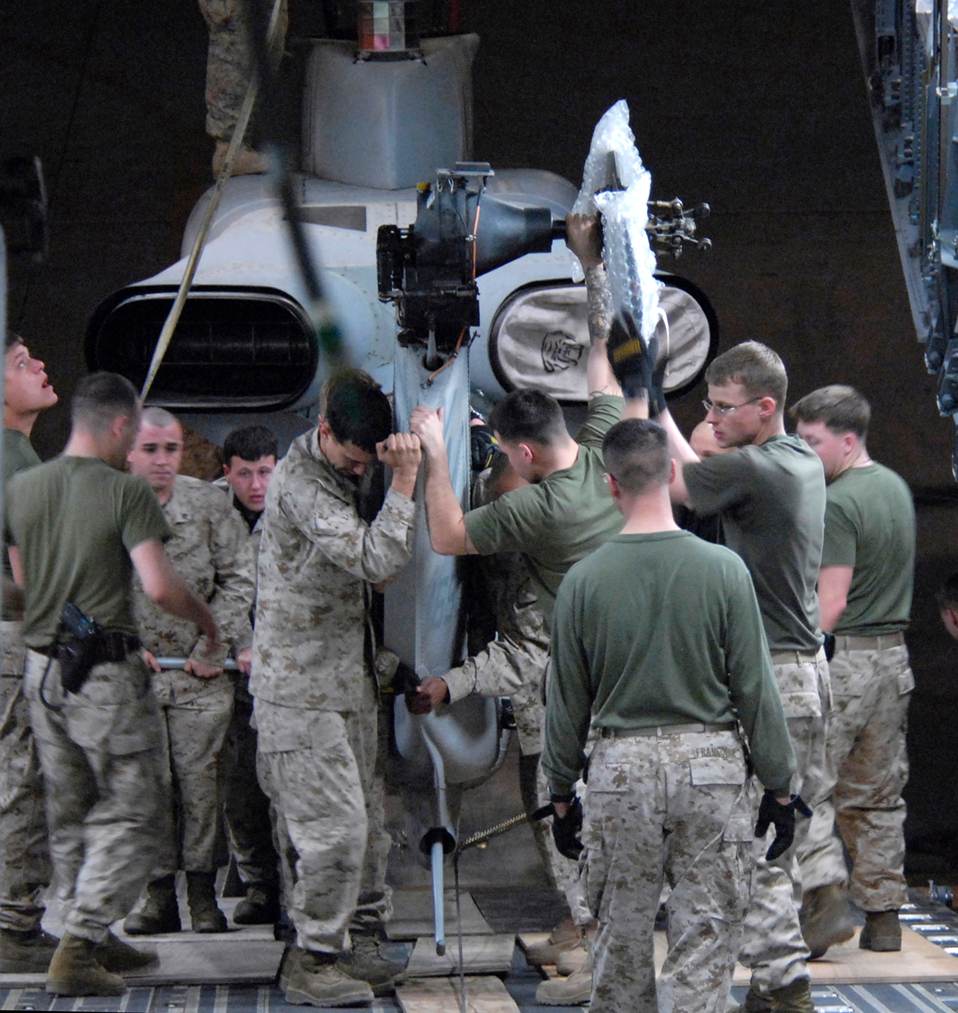 Marines with the 24th Marine Expeditionary Unit load three AH-1W Super Cobra helicopters onto an Air Force C-17 Globemaster III March 16 at Manas Air Base, Kyrgyzstan. The Marines are headed downrange to Afghanistan as part of the troop plus-up authorized by the president in January. The Marines will be a part of the NATO-International Security Assistance Force, conducting operations to extend the authority of the Government of the Islamic Republic of Afghanistan. (U.S. Air Force/Senior Airman Tabitha Kuykendall) 
