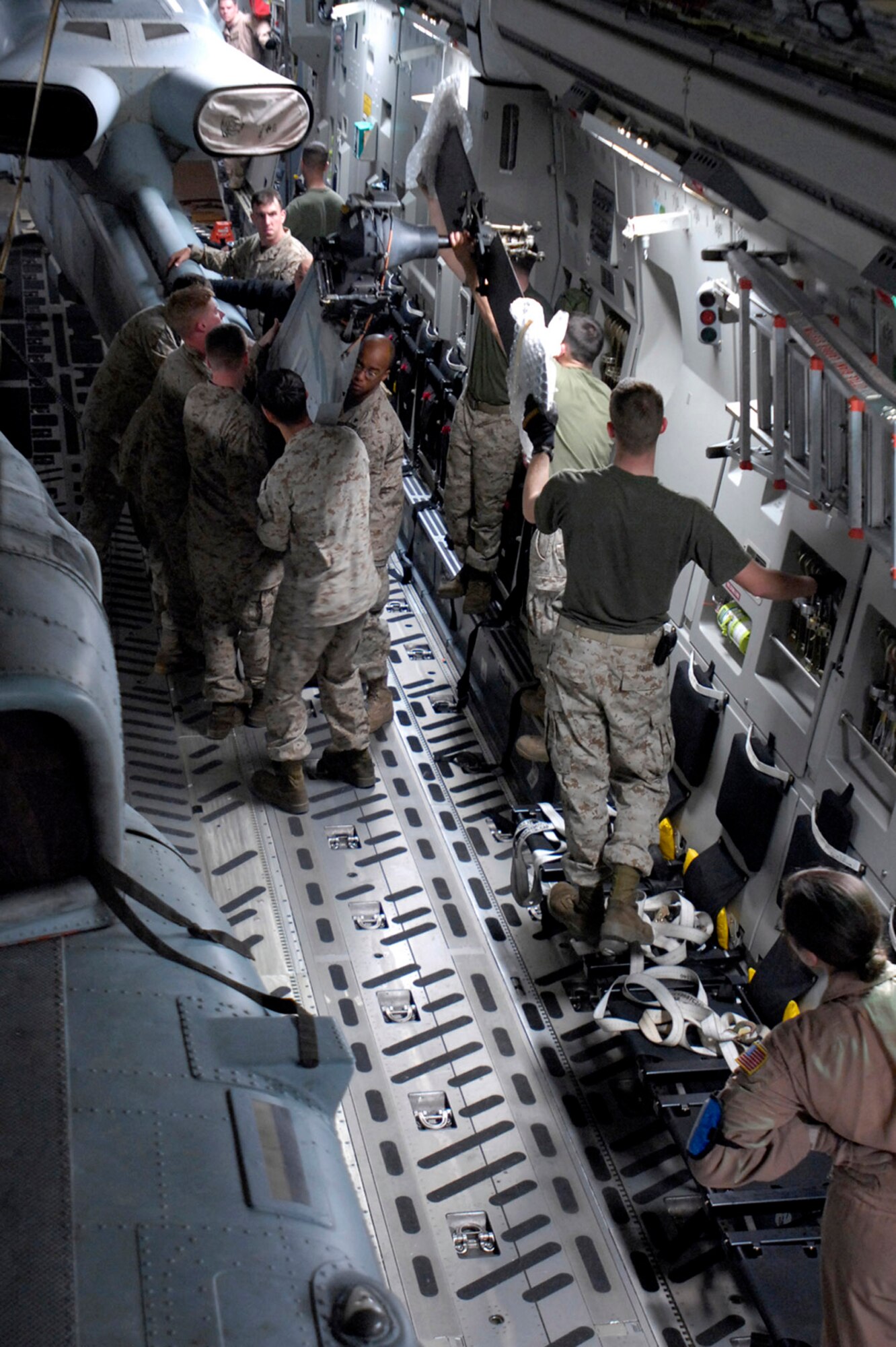 Marines with the 24th Marine Expeditionary Unit load three AH-1W Super Cobra helicopters onto an Air Force C-17 Globemaster III March 16 at Manas Air Base, Kyrgyzstan. The Marines are headed downrange to Afghanistan as part of the troop plus-up authorized by the president in January. The Marines will be a part of the NATO-International Security Assistance Force, conducting operations to extend the authority of the Government of the Islamic Republic of Afghanistan. (U.S. Air Force/Senior Airman Tabitha Kuykendall) 