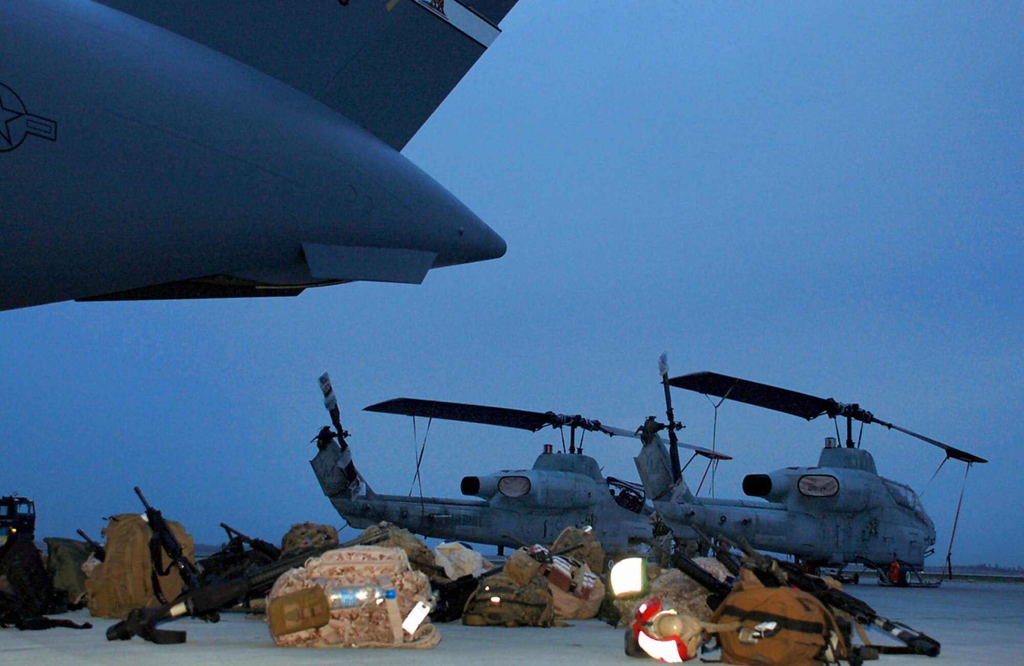 Marines with the 24th Marine Expeditionary Unit load three AH-1W Super Cobra helicopters onto an Air Force C-17 Globemaster III March 16 at Manas Air Base, Kyrgyzstan. The Marines are headed downrange to Afghanistan as part of the troop plus-up authorized by the president in January. The Marines will be a part of the NATO-International Security Assistance Force, conducting operations to extend the authority of the Government of the Islamic Republic of Afghanistan. (U.S. Air Force/Lt. Col. Adriane Craig) 