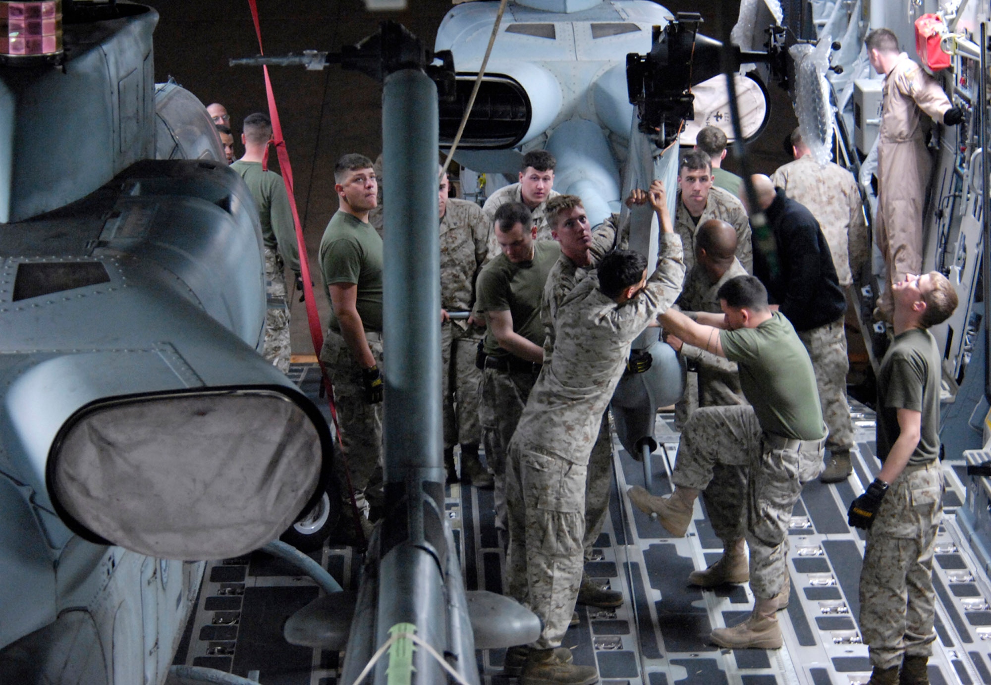 Marines with the 24th Marine Expeditionary Unit load three AH-1W Super Cobra helicopters onto an Air Force C-17 Globemaster III March 16 at Manas Air Base, Kyrgyzstan. The Marines are headed downrange to Afghanistan as part of the troop plus-up authorized by the president in January. The Marines will be a part of the NATO-International Security Assistance Force, conducting operations to extend the authority of the Government of the Islamic Republic of Afghanistan. (U.S. Air Force/Senior Airman Tabitha Kuykendall) 