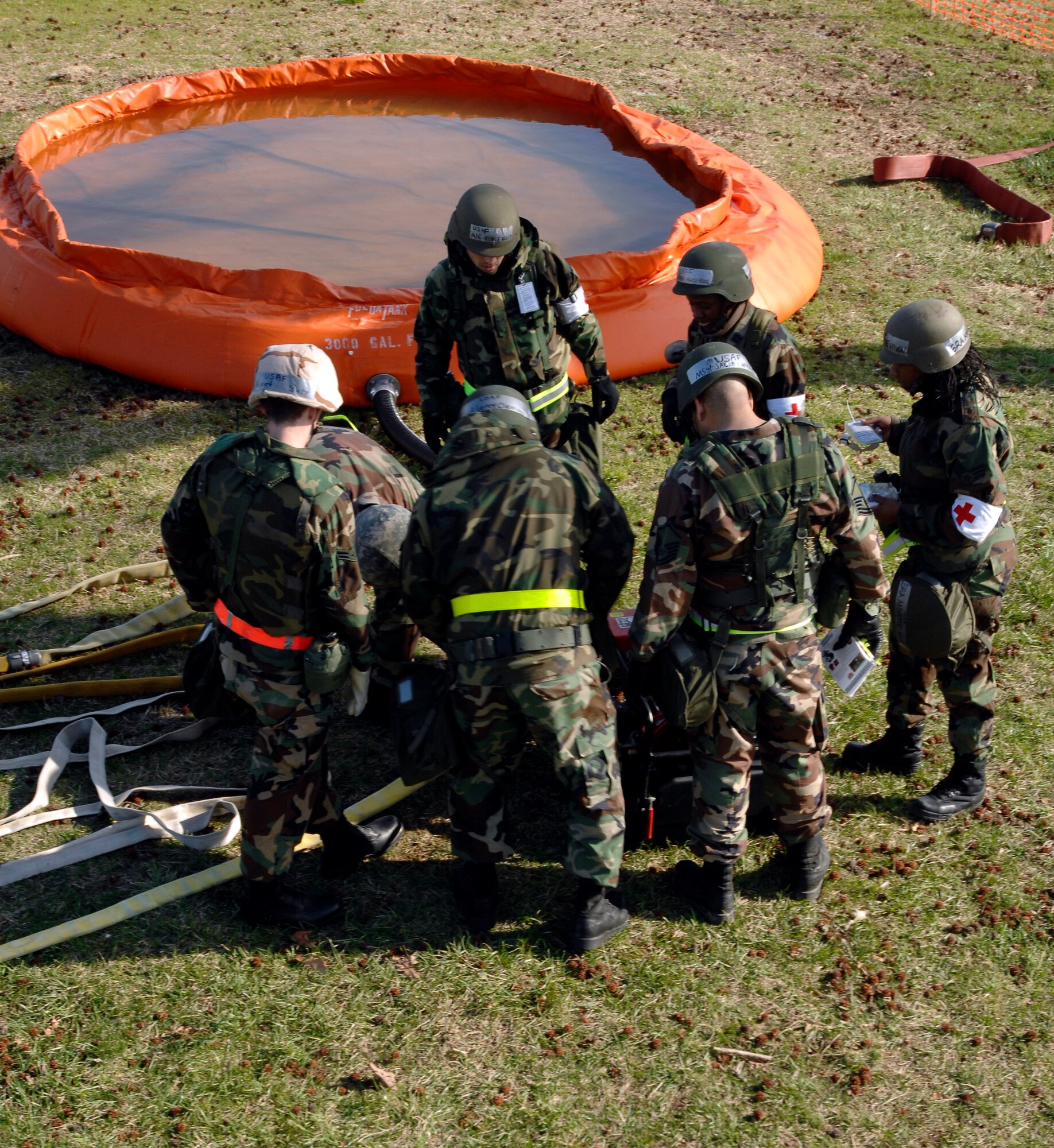LANGLEY AIR FORCE BASE, Va. -- Staff Sgt. Leroy Clemons of the Langley Fire Department, demonstrates how to use emergency fire equipment March 17 in a simulated deployed environment. This training is used to prepare Airmen for real-world combat situations. (U.S. Air Force photo/Senior Airman Christopher L. Ingersoll)