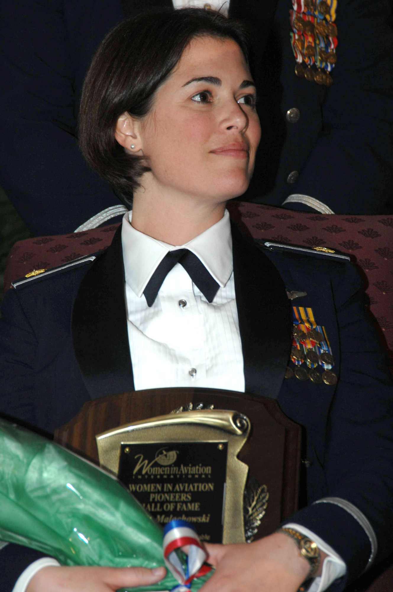 Maj. Nicole Malachowski holds her plaque after being inducted into the Women in Aviation International's Pioneer Hall of Fame March 15 at the Town and Country Convention Center in San Diego. The major, who piloted the Thunderbirds right wing No. 3, was recognized for being the first female pilot to be part of a U.S. military flight demonstration team. (U.S. Air Force photo/Master Sgt. Bill Kimble) 
