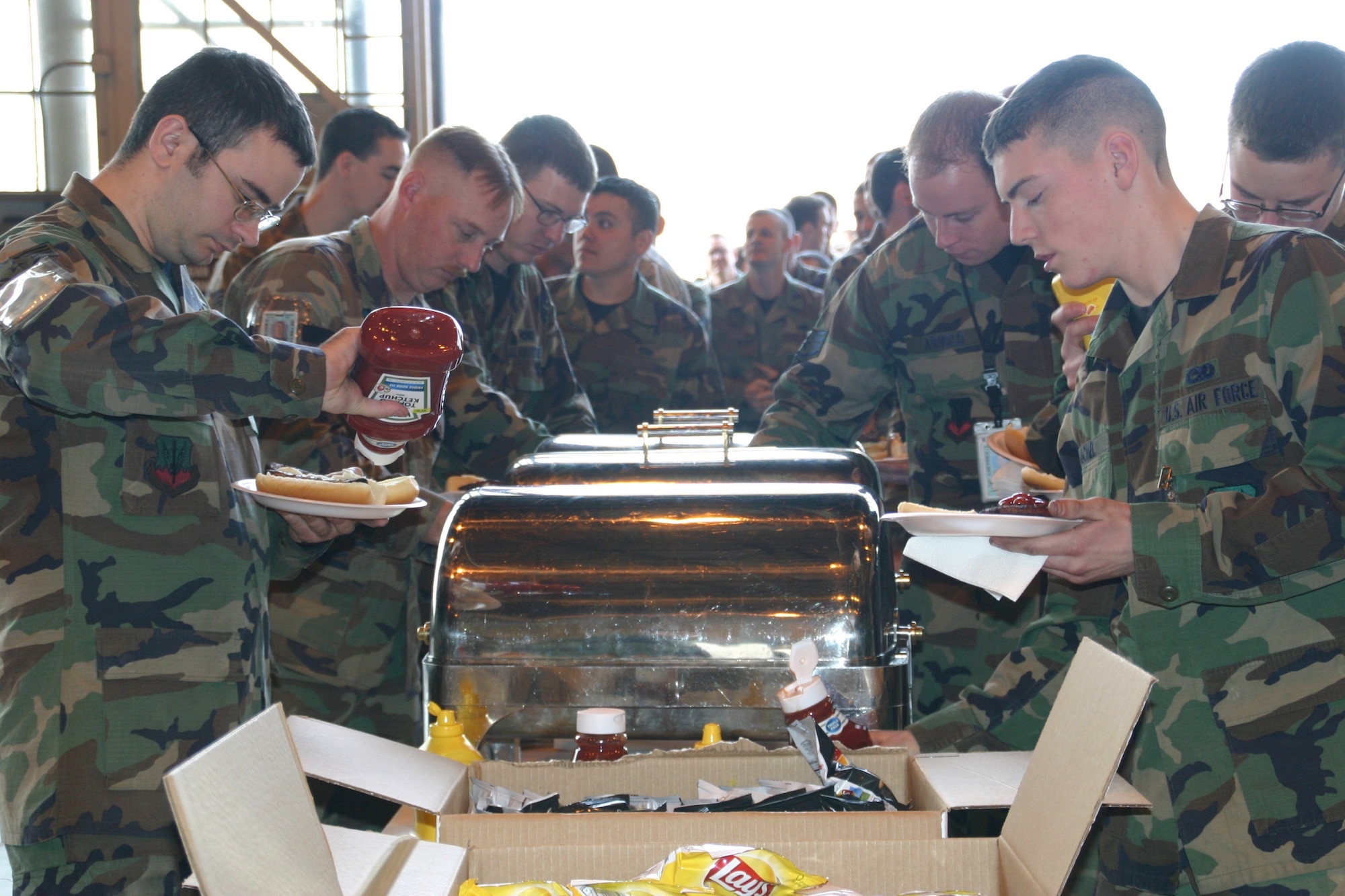 Airmen of the 552nd Maintenance Group enjoy a burger burn in celebration of their successful completion of the ACC LSET inspection Feb. 25-29.