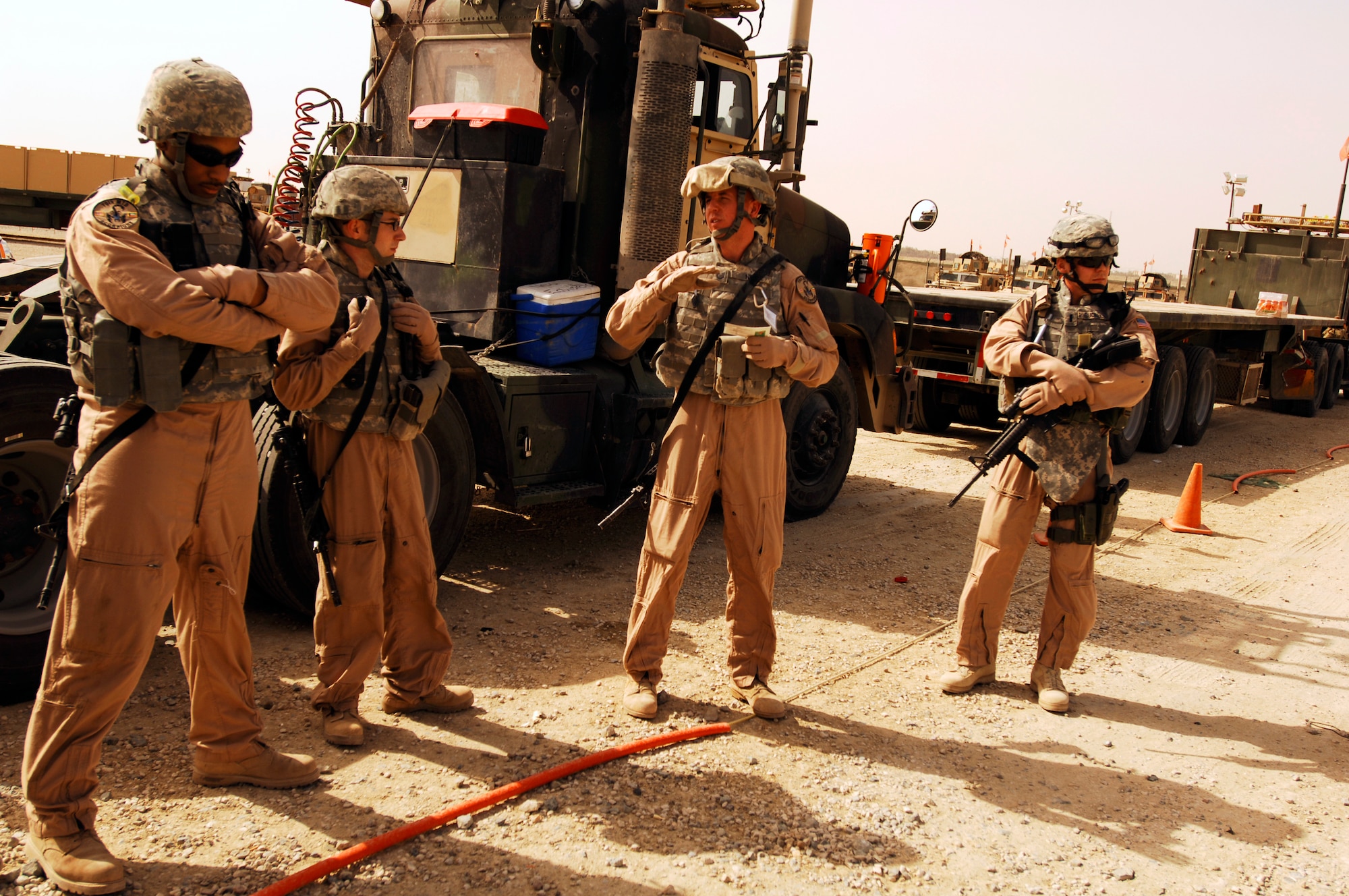 SOUTHWEST ASIA -- Technical Sgt. Scott Neu (center), a convoy commander from the 586th Expeditionary Logistics Readiness Squadron, 70th Medium Truck Detachment, gives a safety briefing before leading a recent convoy from an Army camp in the Persian Gulf Region. The Airmen of the 70th and 424th MTDs assigned to the 586th ELRS are in-lieu-of forces supporting the Army Support Line-Haul Convoy movements in and out of Iraq. (U.S. Air Force photo/ Staff Sgt. Patrick Dixon) 