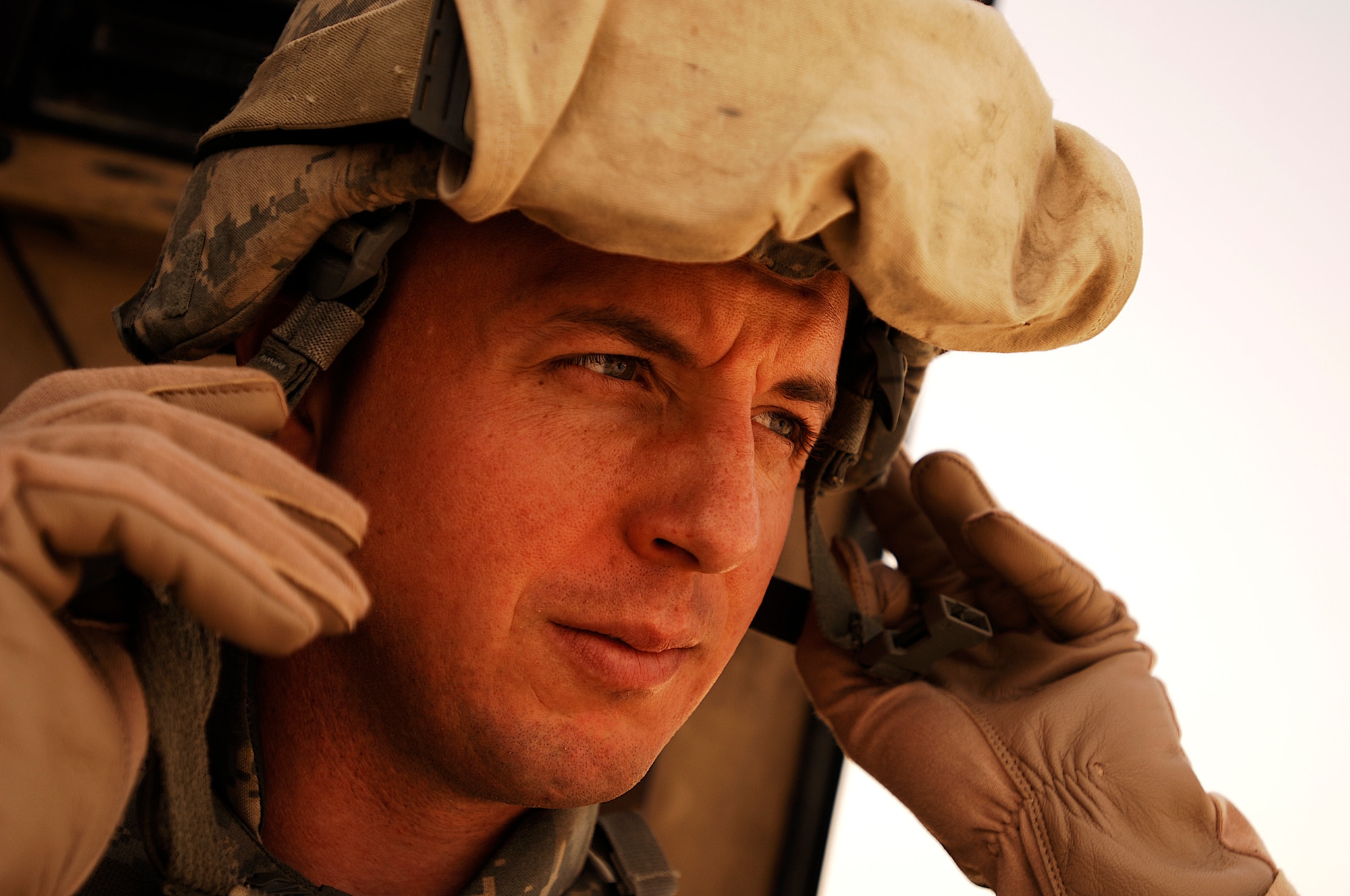 SOUTHWEST ASIA -- Technical Sgt. Scott Neu, a convoy commander from the 586th Expeditionary Logistics Readiness Squadron, 70th Medium Truck Detachment, gears up before leading a recent convoy from an Army camp in the Persian Gulf Region. The Airmen of the 70th and 424th MTDs assigned to the 586th ELRS are in-lieu-of forces supporting the Army Support Line-Haul Convoy movements in and out of Iraq. Sergeant Neu is deployed from Eglin Air Force Base, Fla.  (U.S. Air Force photo/ Staff Sgt. Patrick Dixon)