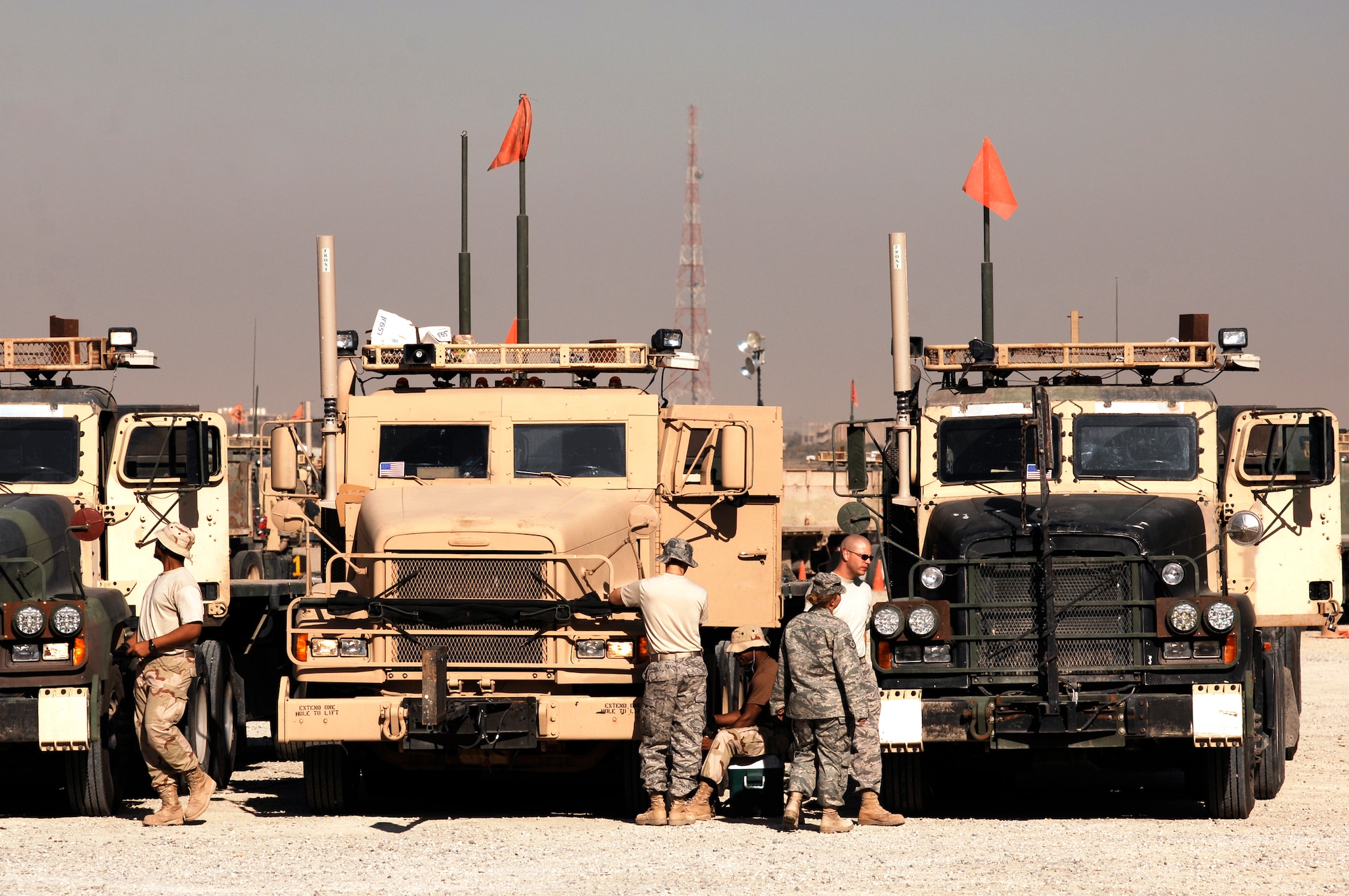 SOUTHWEST ASIA -- Members from the 586th Expeditionary Logistics Readiness Squadron, 70th Medium Truck Detachment, perform Preventive Maintenance Checks and Services on M915A3 tractor-trailer trucks prior to departing on a recent convoy from an Army camp in the Persian Gulf Region. The Airmen of the 70th and 424th MTDs assigned to the 586th ELRS are in-lieu-of forces supporting the Army Support Line-Haul Convoy movements in and out of Iraq. (U.S. Air Force photo/ Staff Sgt. Patrick Dixon)  