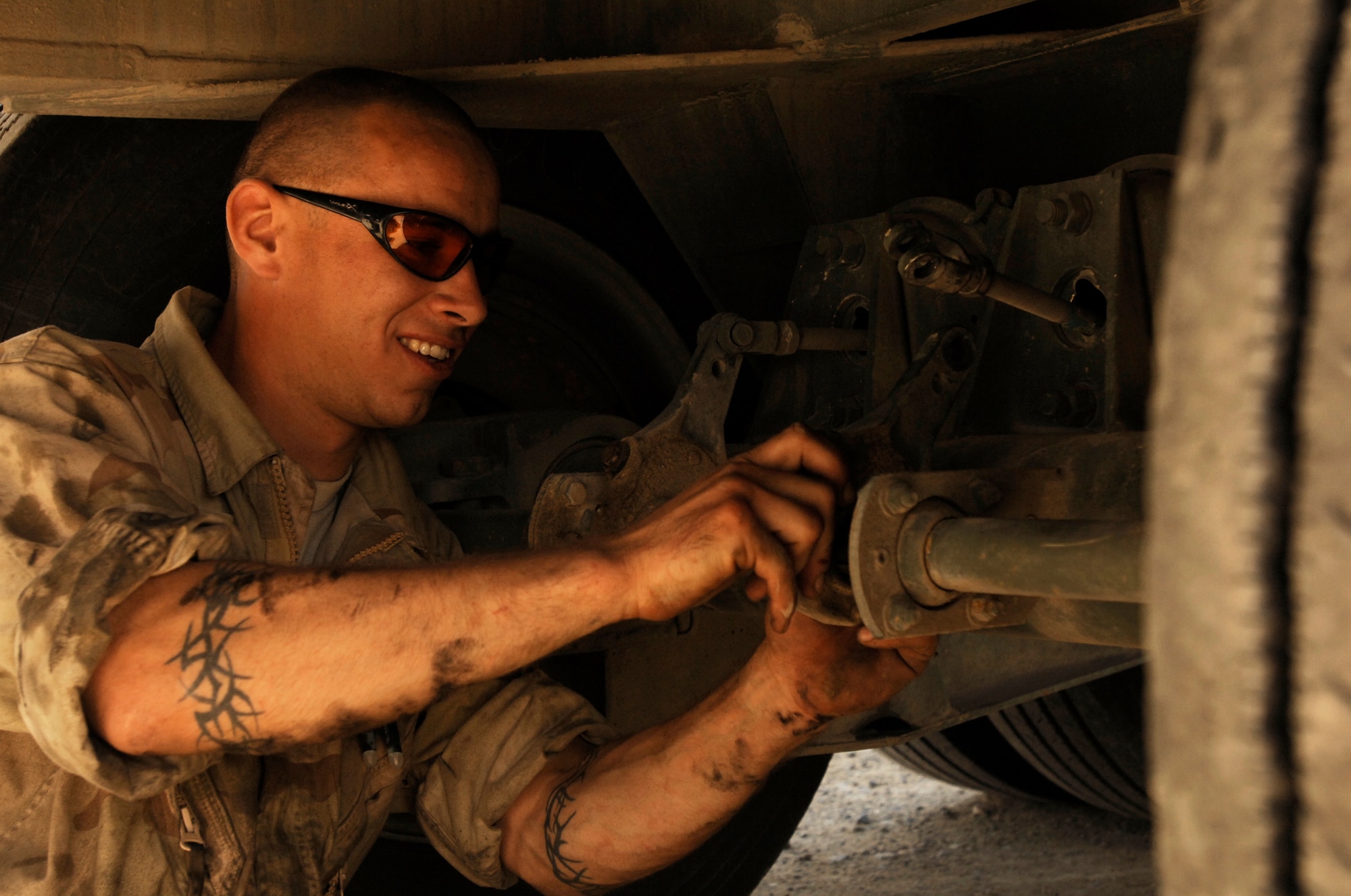 SOUTHWEST ASIA -- Staff Sgt. Tibor Pecsuk, a vehicle maintainer deployed to the 586th Expeditionary Logistics Readiness Squadron, 70th Medium Truck Detachment, performs scheduled maintenance on a M915A3 tractor-trailer truck recently at an Army camp in the Persian Gulf Region. The Airmen of the 70th and 424th MTDs assigned to the 586th ELRS are in-lieu-of forces supporting the US Army Support Line-Haul Convoy movements in and out of Iraq.  Sergeant Pecsuk is deployed from the 437th Logistics Readiness Squadron, Charleston Air Force Base, S.C. (U.S. Air Force photo/ Staff Sgt. Patrick Dixon)