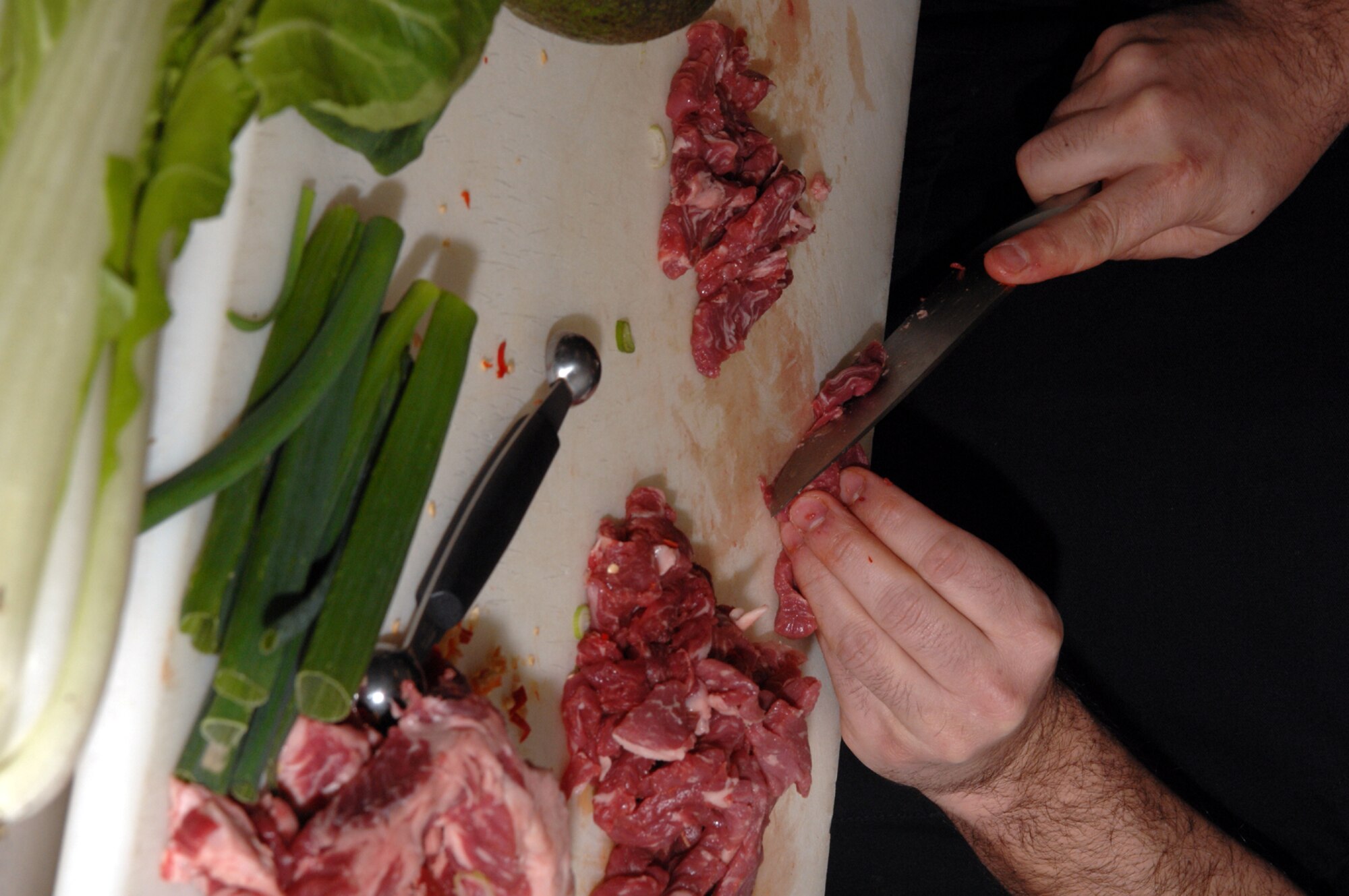 SPANGDAHLEM AIR BASE, Germany -- Master Sgt. Joe Santiago, 52nd Dental Squadron, slices steak during the Iron Chef competition held by the 52nd Services Squadron, March 14, 2008. Sergeant Santiago won the cooking challenge. (U.S. Air Force photo/Staff Sgt. Kristin Ruleau) 
