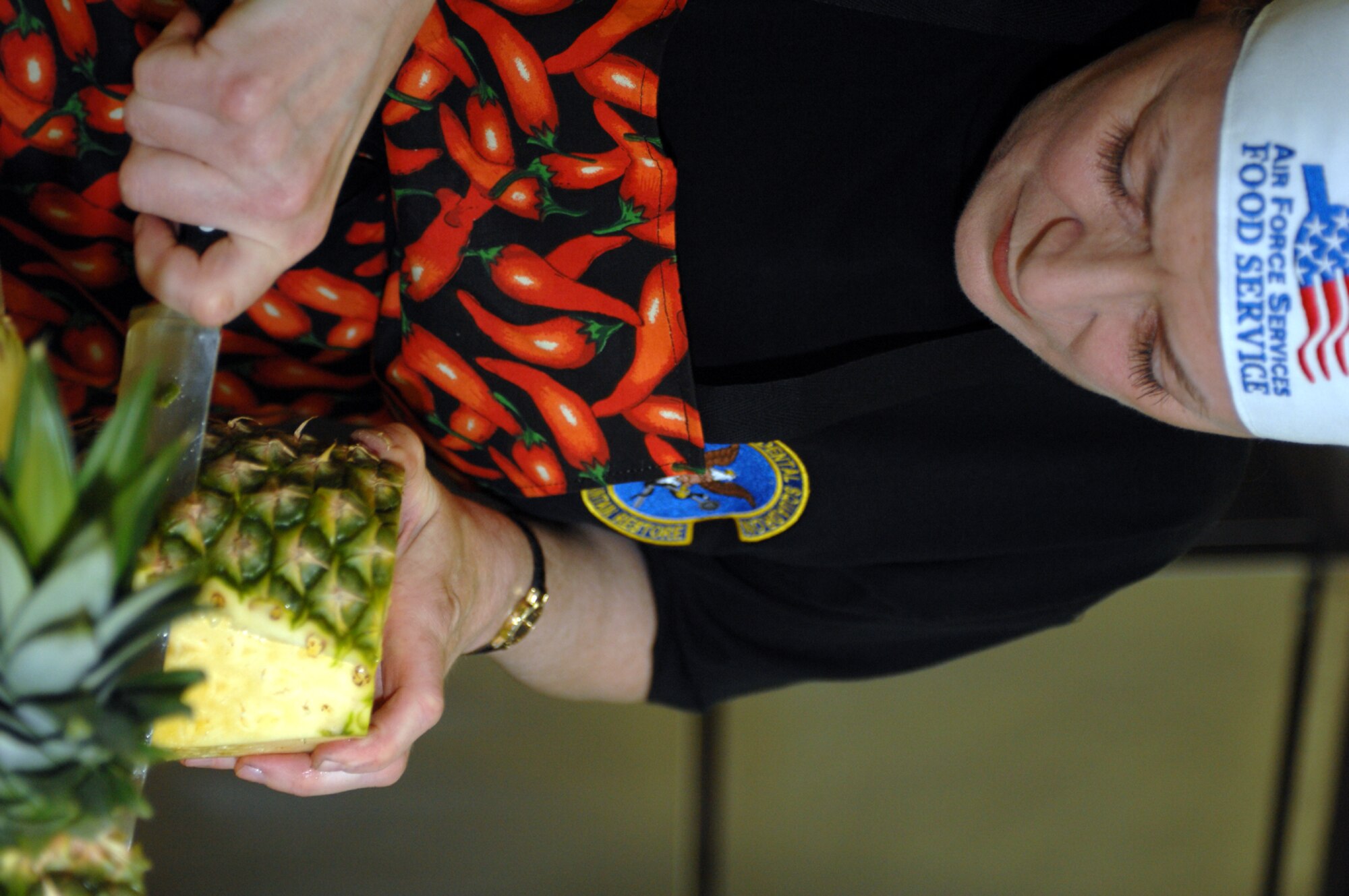 SPANGDAHLEM AIR BASE, Germany -- Master Sgt. Diane Jernigan, 52nd Dental Squadron, slices pineapple during the Iron Chef competition held by the 52nd Services Squadron, March 14, 2008. (U.S. Air Force photo/Staff Sgt. Kristin Ruleau)