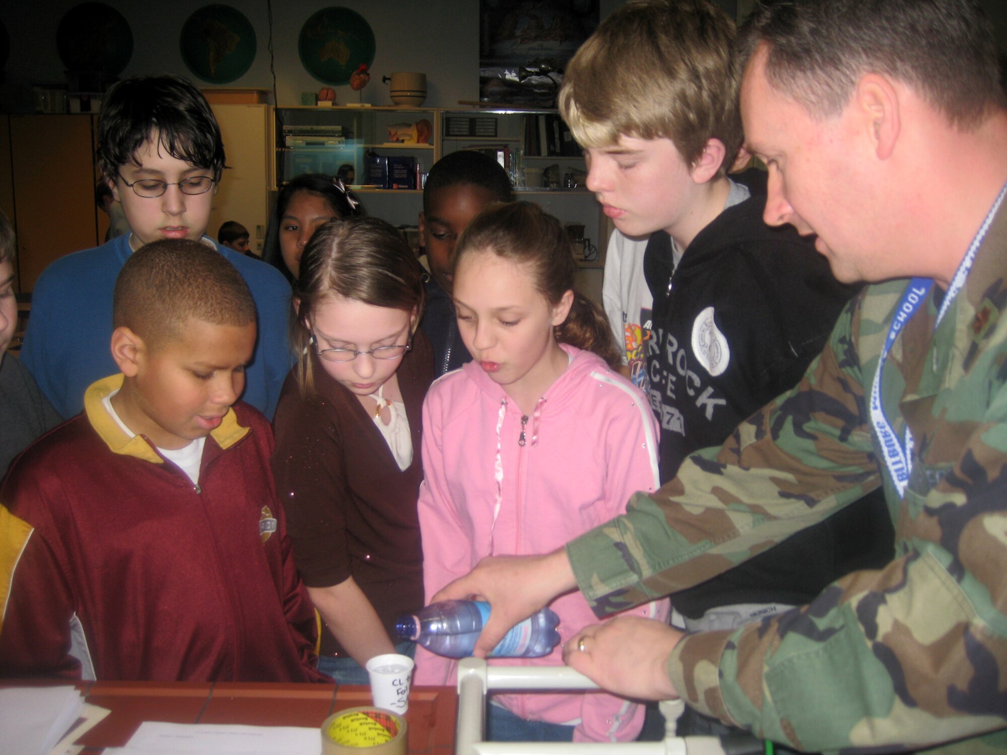 SPANGDHALEM AIR BASE, Germany – Maj. (Dr.) Daniel Gullekson, 52nd Medical Group, teaches Bitburg Middle School students refraction of light through different mediums. Airmen with the 52nd MDG are working with school’s science department to increase student’s awareness and interest in science. (Courtesy photo)