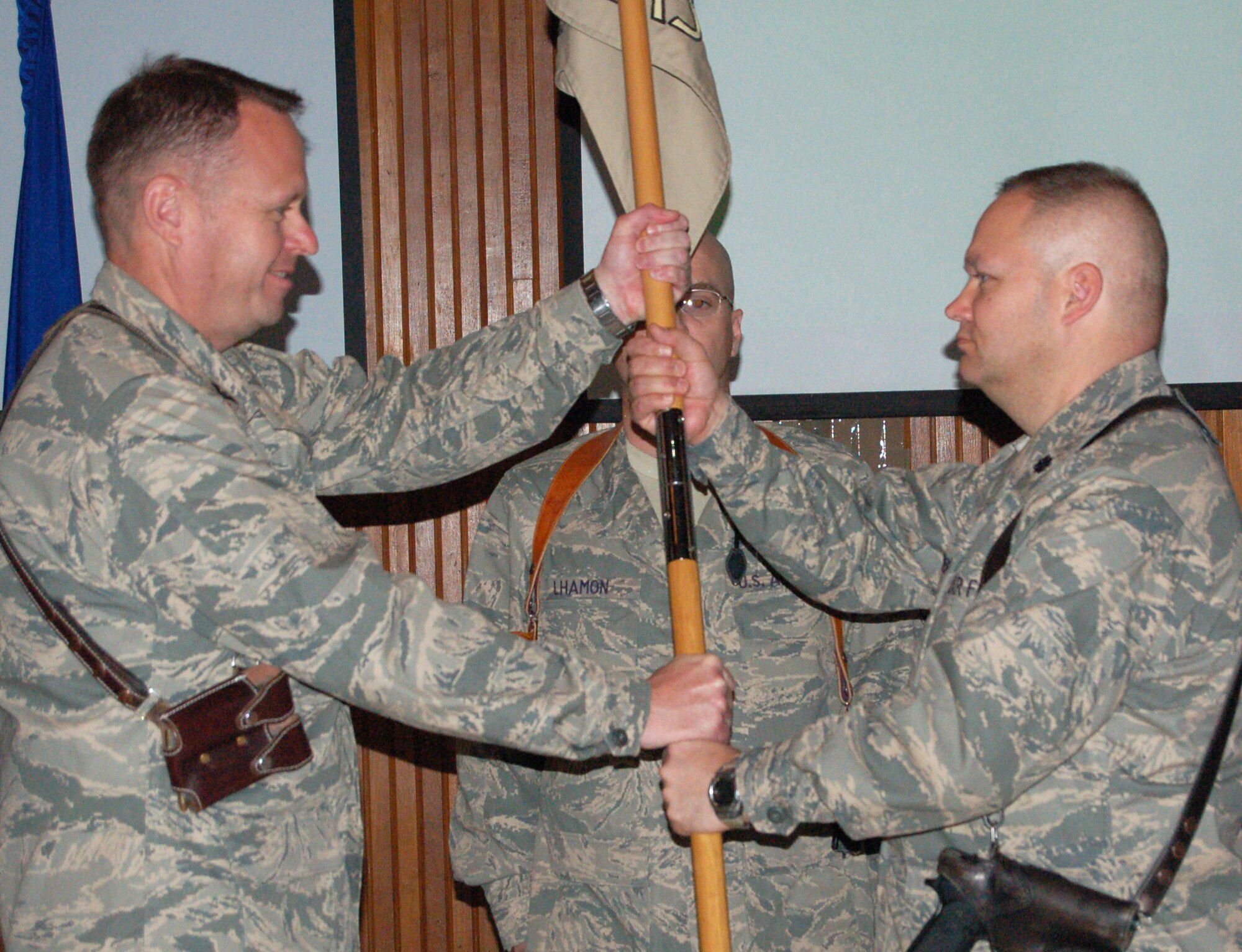 SATHER AIR BASE, Iraq -- Lt. Col. Dana Pelletier, deployed from Spangdahlem Air Base, Germany, takes the 447th Expeditionary Logistics Readiness Squadron's guide-on from Col. Fred Cheney, 447th AEG commander, during the 447 ELRS change of command ceremony here March 10, 2008. (U.S. Air Force photo)