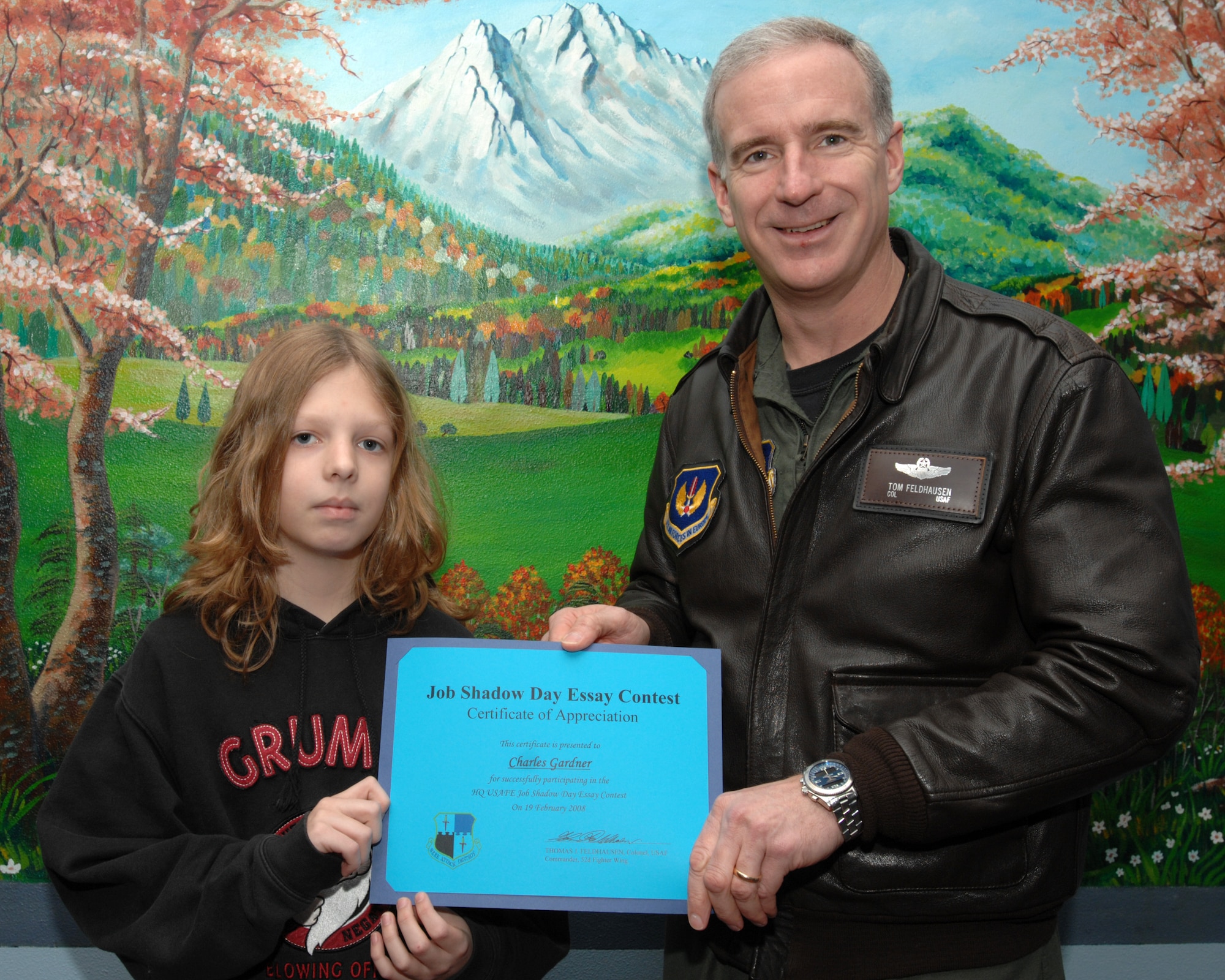 SPANGDAHLEM AIR BASE, Germany – Col. Thomas Feldhausen, 52nd Fighter Wing commander, presents Charles Gardner, son of Marianne and Chief Master Sgt. Steven Gardner, 52nd Aircraft Maintenance Squadron, with a certificate for his winning Job Shadow Day essay March 18, 2008. Charles is a seventh grader at Spangdahlem Middle School. Charles shadowed Colonel Feldhausen during the school’s Job Shadow Day. (U.S. Air Force photo/Airman 1st Class Jenifer Calhoun) 