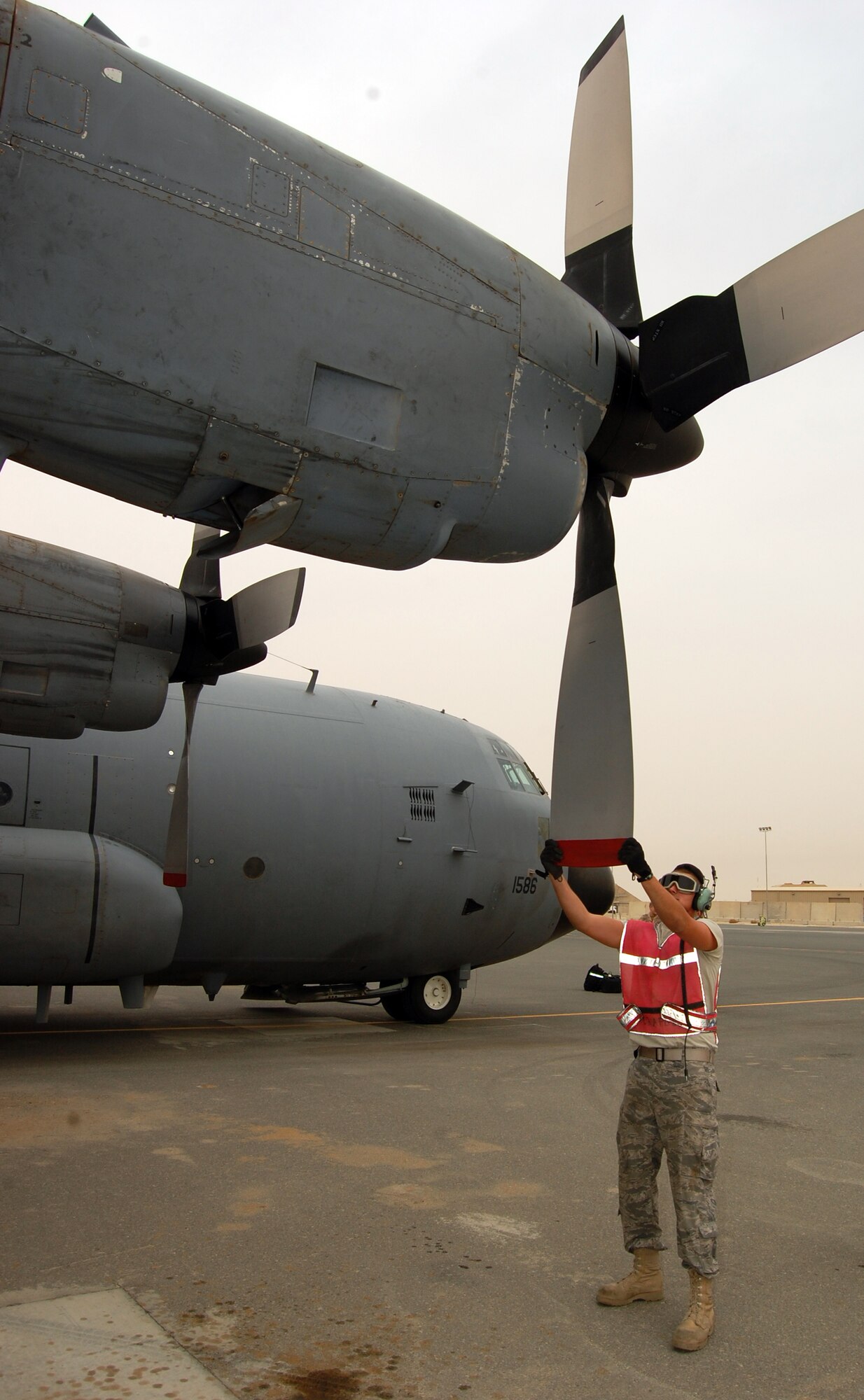 SOUTHWEST ASIA -- Airman Cory Francis, a C-130 crewchief deployed with the 386th Expeditionary Aircraft Maintenance Squadron tees-up the props on an EC-130H Compass Call aircraft for a post-flight inspection at an air base in the Persian Gulf Region March 18, 2008. Airman Francis is deployed from the 755th AMXS out of Davis-Monthan Air Force Base, Ariz., supporting the Global War on Terror. (Air Force photo/Tech. Sgt. Michael O’Connor)