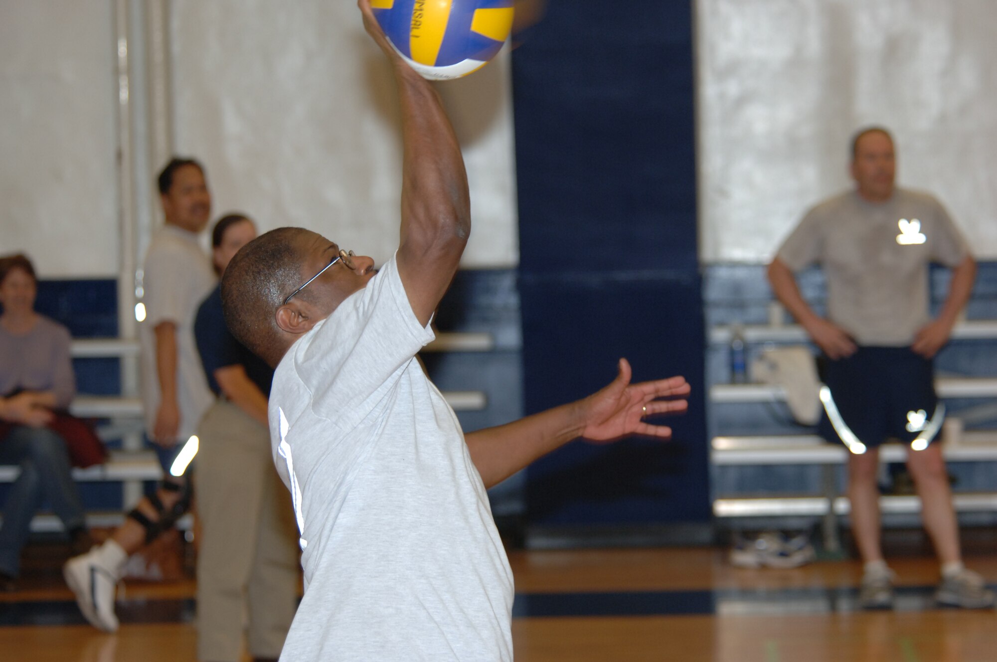 MISAWA AIR BASE, Japan -- Chief Master Sgt. James Moore, with the 35th Communications Squadron, serves the ball during the Eagles vs. Chiefs volleyball game at the Potter Fitness Center, March 14, 2008.  The Eagles scored the first point in the game but the Chief's ended the competition with victory.  (U.S. Air Force photo by Senior Airman Robert Barnett)