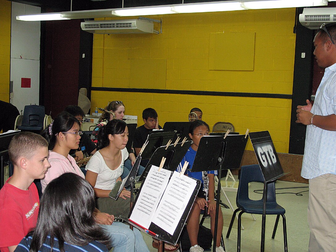 Senior Airman Rebecca Cook, a boundary protection specialist with the 36th Comunications Squadron plays with the Guam Territorial Band. She has been with the band a little over a month. (U.S. Air Force photo by Airman 1st Class Carissa Wolff)