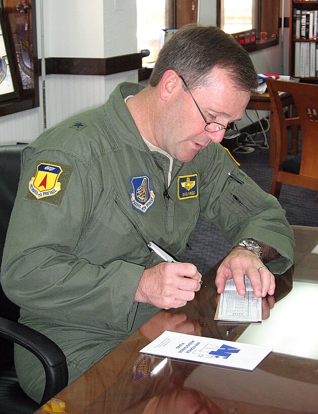 Brig. Gen. Douglas Owens, 36th Wing commander, makes his Air Force Assistance Fund donation March. 19. The yearly fund raiser offers Airmen the opportunity to contribute to any of the four official Air Force charitable organizations. This year's AFAF will run through April 28. To make a donation, contact your unit AFAF project officers or Andersen's installation AFAF project officers Capt. Scott Sitterson at 366-5253 and Capt. Patricia Gruen and 366-6041. (U.S. Air Force photo by Airman 1st Class Carissa Wolff)