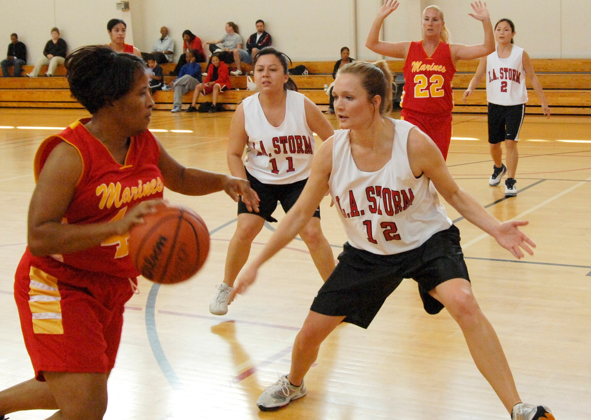 Ayesha DesParte, 61st CS, plays defense against a player from Twenty Nine Palms Marine Corps Base in military basketball league play.  Twenty Nine Palms edged out Los Angeles AFB’s Storm 54 to 50. (Photo by Lou Hernandez)