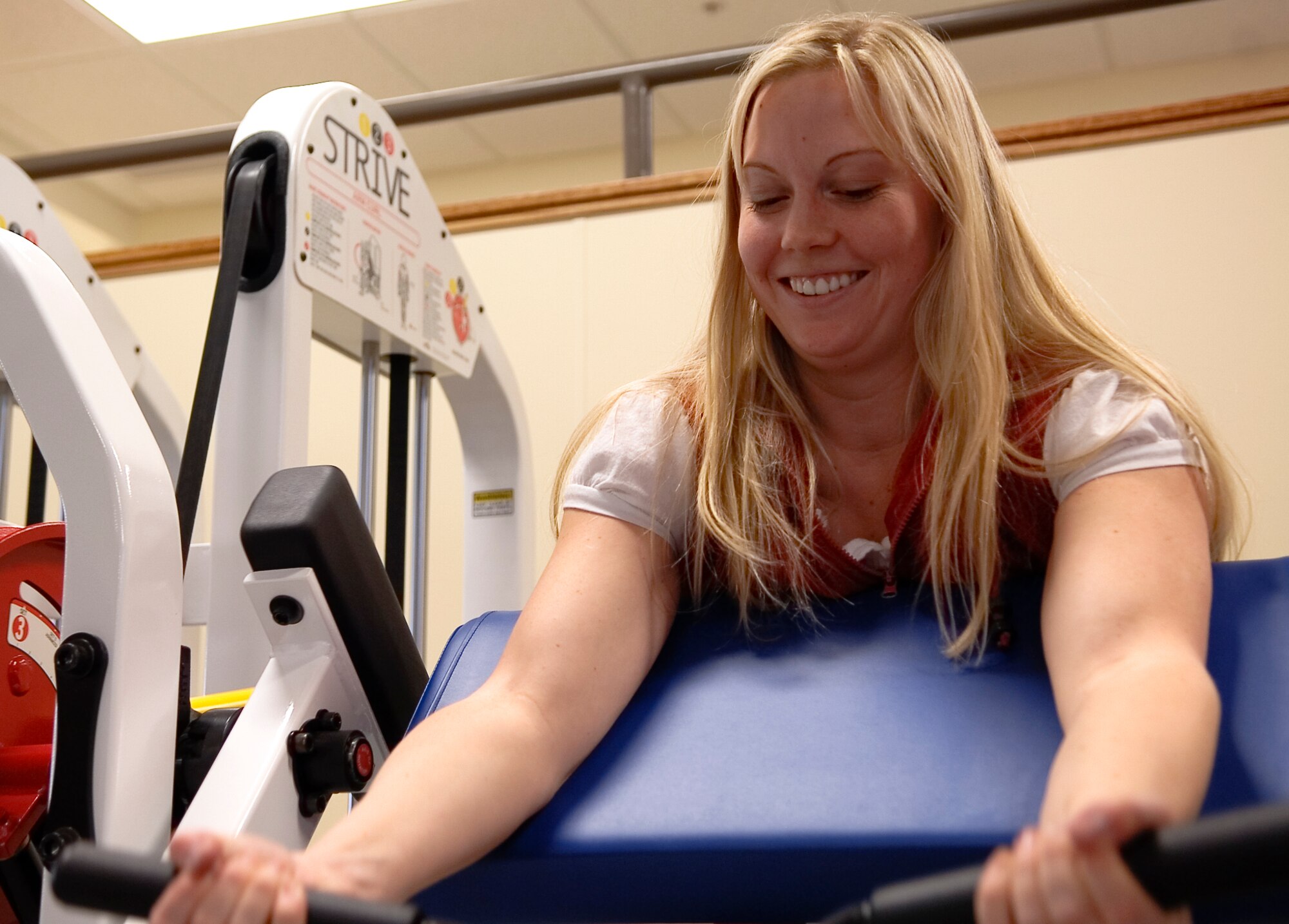 FAIRCHILD AIR FORCE BASE, Wash. – Alyson Kresser, 92nd Medical Support Squadron dietician, attempts to “raise the bar” during a demonstration on new fitness facility equipment at the 336th Training Group fitness center March 18. The new equipment is designed to both isolate and distribute weight throughout the lifting movement. (U.S. Air Force photo/Airman 1st Class Joshua Chapman)