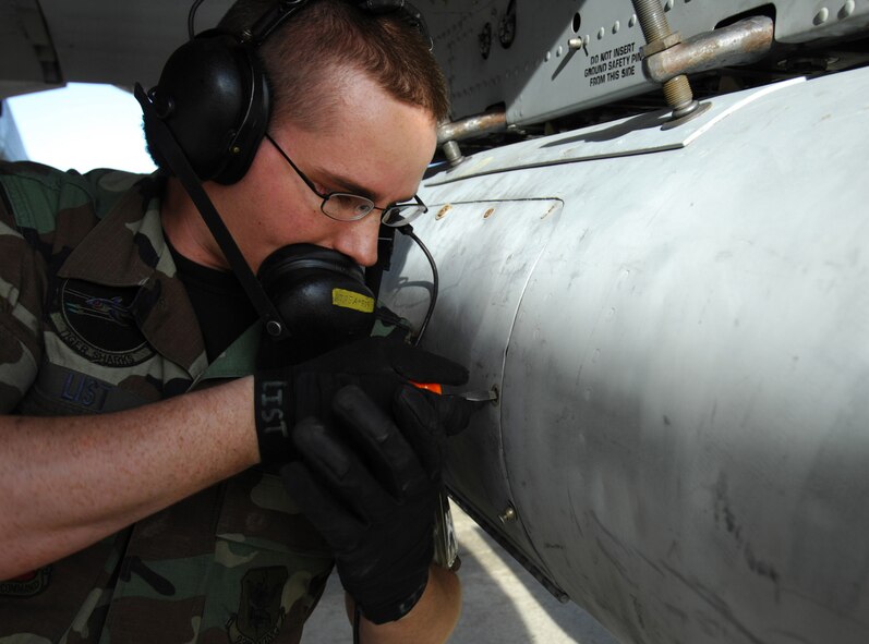 MOODY AIR FORCE BASE, Ga. -- A-10C Thunderbolt II Crew Chief Senior Airman Christian List, secures the panel of an A-10 travel pod here, March 20.  The 75th Fighter Squadron is sending more than 150 personnel to Nellis Air Force Base, Nev.to participate in the Green Flag exercise. (U.S. Air Force photo by Staff Sgt. Joshua T. Jasper)