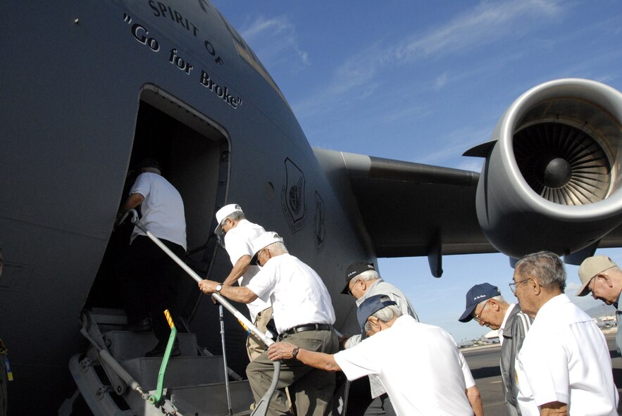 HICKAM AIR FORCE BASE, Hawaii -- Veterans of the famed 442nd Regimental Combat Team and the 100th Infantry Battalion climb on board the “Spirit of Go for Broke”.  Waiting for more than a year and a half after the June, 14 2006 christening of Hickam’s seventh C-17, Globemaster III, added to Hickam’s fleet of eight –the men for whom it was named after finally get their ride on the aircraft. They took to the skies for a 45-minute flight around some of the Hawaiian Islands. (U.S. Air Force photo/Tech. Sgt. Tom Czerwinski)