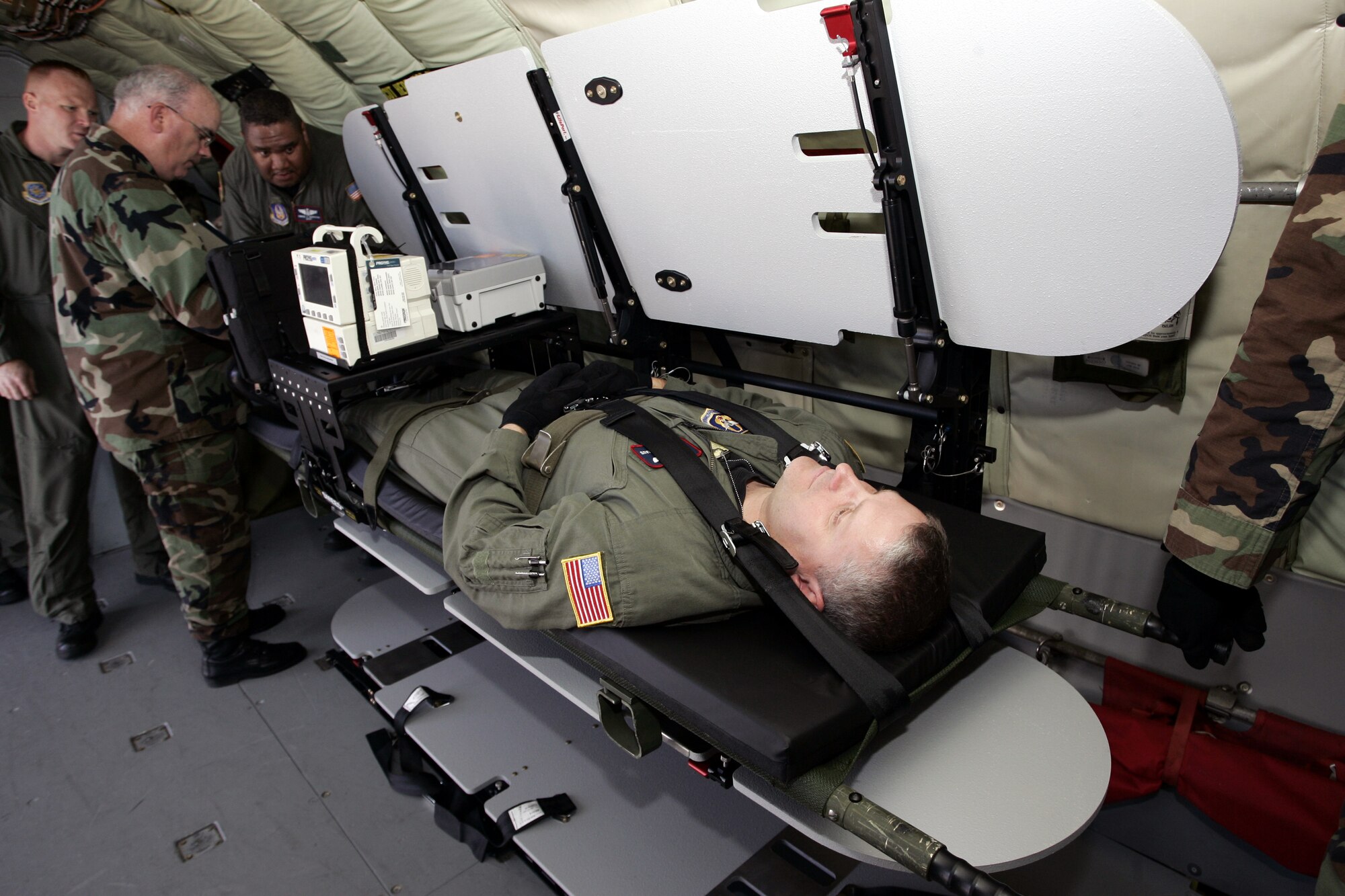 A KC-135 Stratotanker aircrew member from the 108th Air Refueling Wing, McGuire Air Force Base, N.J., lays on a stacking litter system as part of a demonstration for the system by the Air Mobility Battlelab June 22, 2007, on McGuire.  Air Mobility Command's Surgeon General Readiness Division has said the versatile and portable system will contribute to a "more robust and flexible aeromedical evacuation system."  The Air Mobility Battlelab, which headed this initiative, is located in the U.S. Air Force Expeditionary Center on Fort Dix, N.J.  (U.S. Air Force Photo/Master Sgt. Bob Lorusso) 