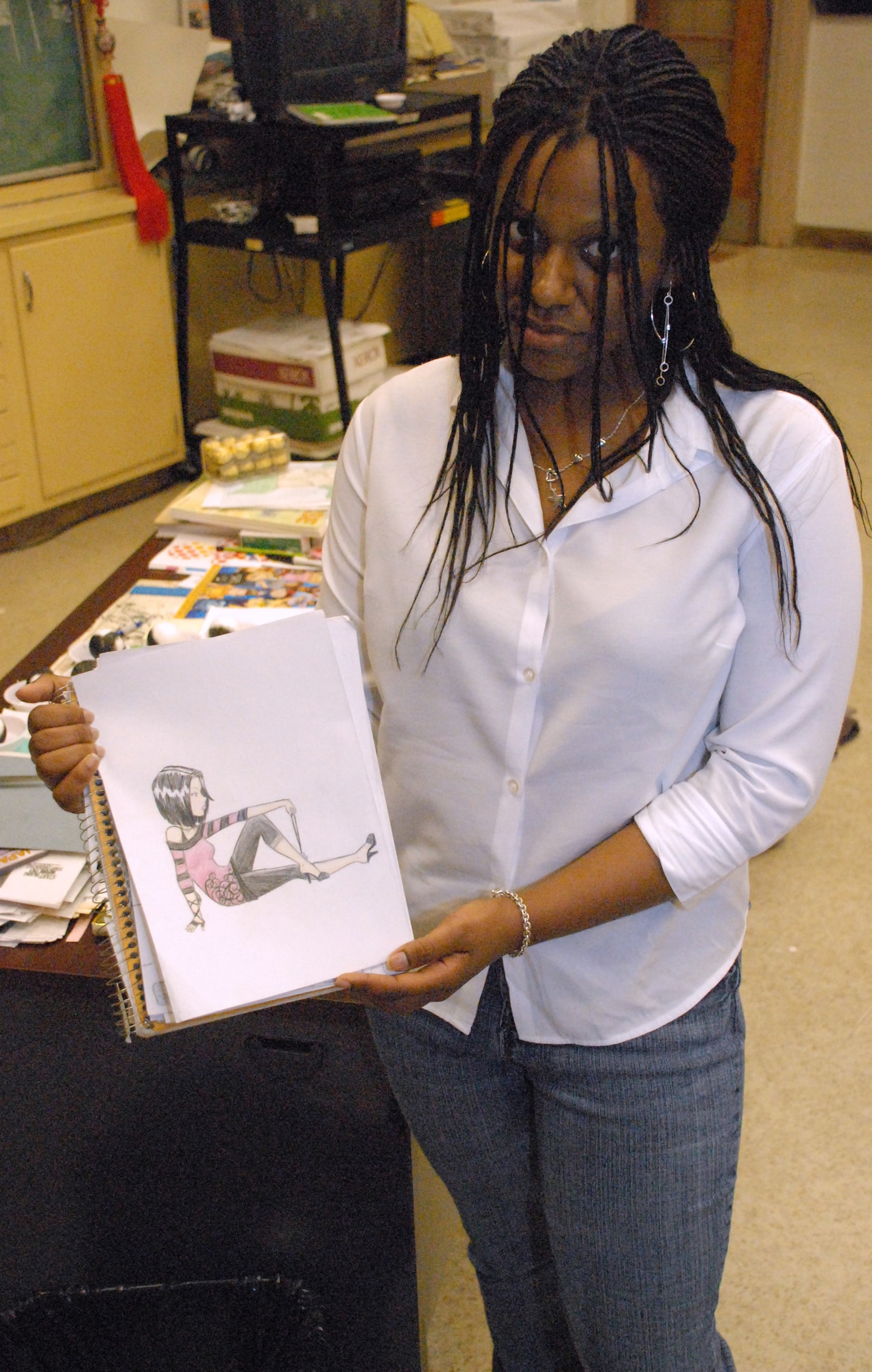 Briana Slater, an 8th-grader at Dover Air Base Middle School and daughter of Master Sgt. Mark Slater, 436th Aircraft Maintenance Squadron, shows a ‘Manga,’ she created March 19 here. As part of the ninth-annual Iwanuma City and city of Dover exchange program, Japanese students taught Dover students and parents about manga, Japanese comic art, and many other subjects relevant to Japanese culture.  (U.S. Air Force photo/Tech. Sgt. Kevin Wallace)