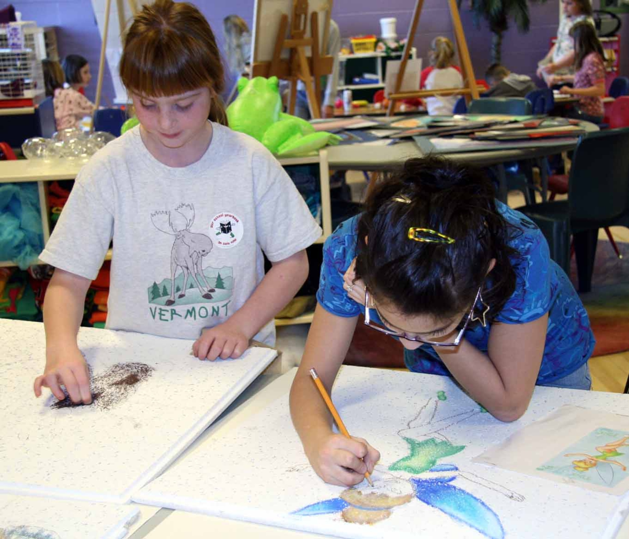 Young artists Kayla Taylor, age 9, and Erica Foster, age 12, learn how to work in various art media during Ms. Yun's fine art class at the Tinker Youth Center.  (Air Force photo by Becky Pilifant)