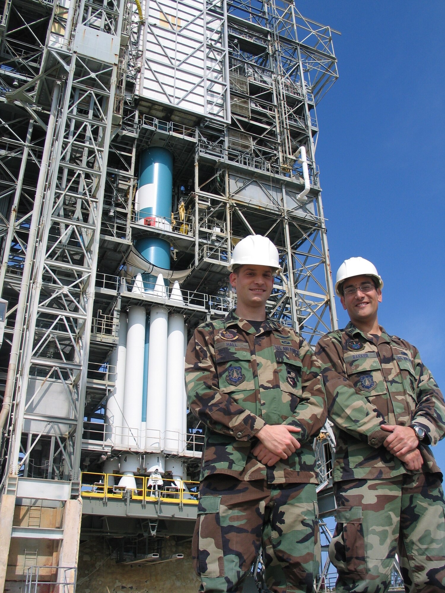 1st. Lt. Josh Hall (left) of the 1st Space Launch Squadron and Capt. Bill Bakker of the 45th Launch Support Squadron with the Delta II booster they helped launch March 15 from Complex 17A at Cape Canaveral Air Force Station.