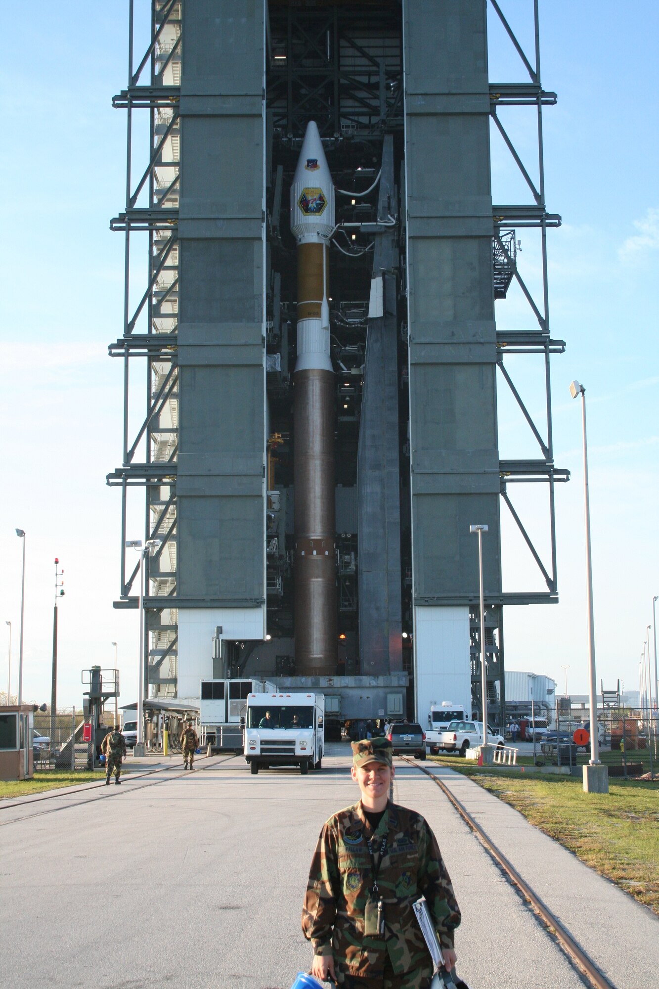 Capt. Davina Fallaw stands in front of an Atlas V booster at Cape Canaveral. Captain Fallaw's flawless support of the Atlas V program has garnered her the Gen. Charles Horner award.