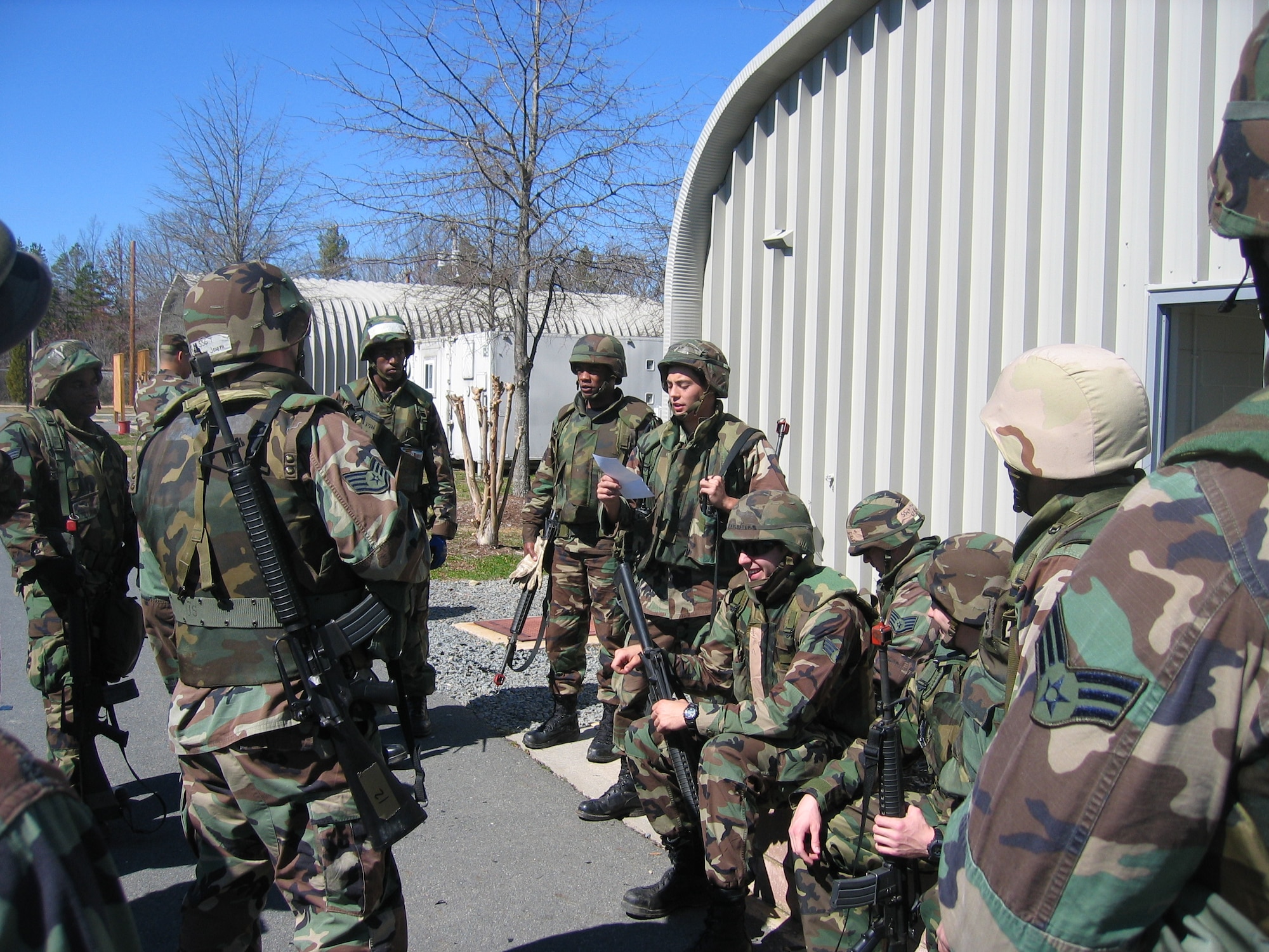 2nd Lt. Esamu Cooper, 43rd Civil Engineer Squadron, uses his notes to brief other civil engineers on the convoy operation at hand before running an exercise scenario. Throughout the Field Training Exercise, Lieutenant Cooper and the rest of his team got real-time hands on training with specialized equipment for each craftsmen, work-party security, as well as vehicle and convoy operations.  (U.S. Air Force Photo by Maj. Erik Lagerquist)