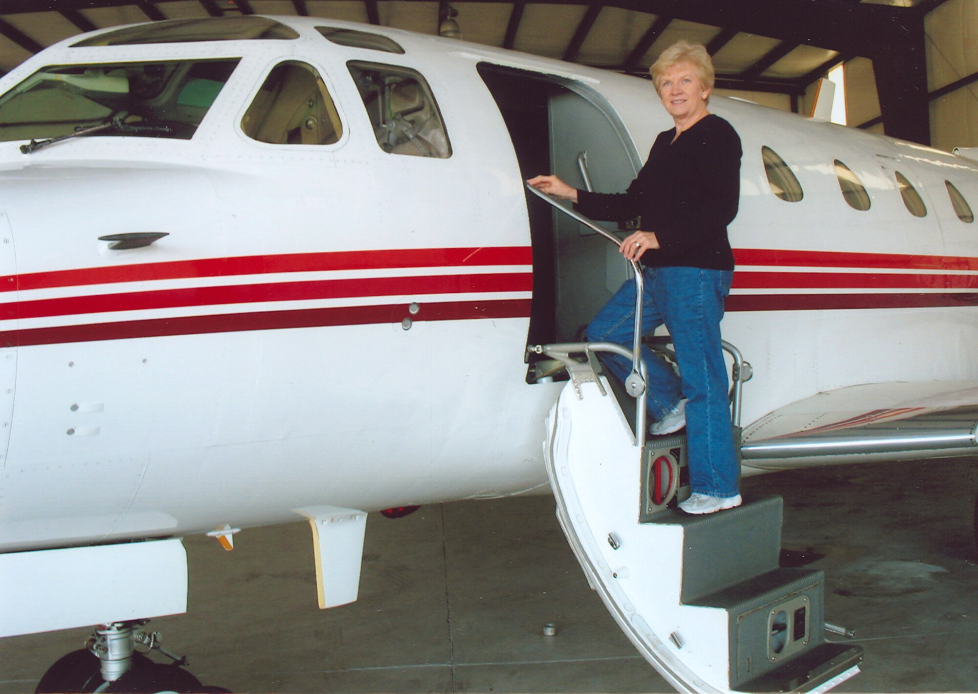 Here Betty Spray poses on the ladder of a North American T-39 Sabreliner on her way to conduct preflight checks prior to a short flight. (Photo provided)