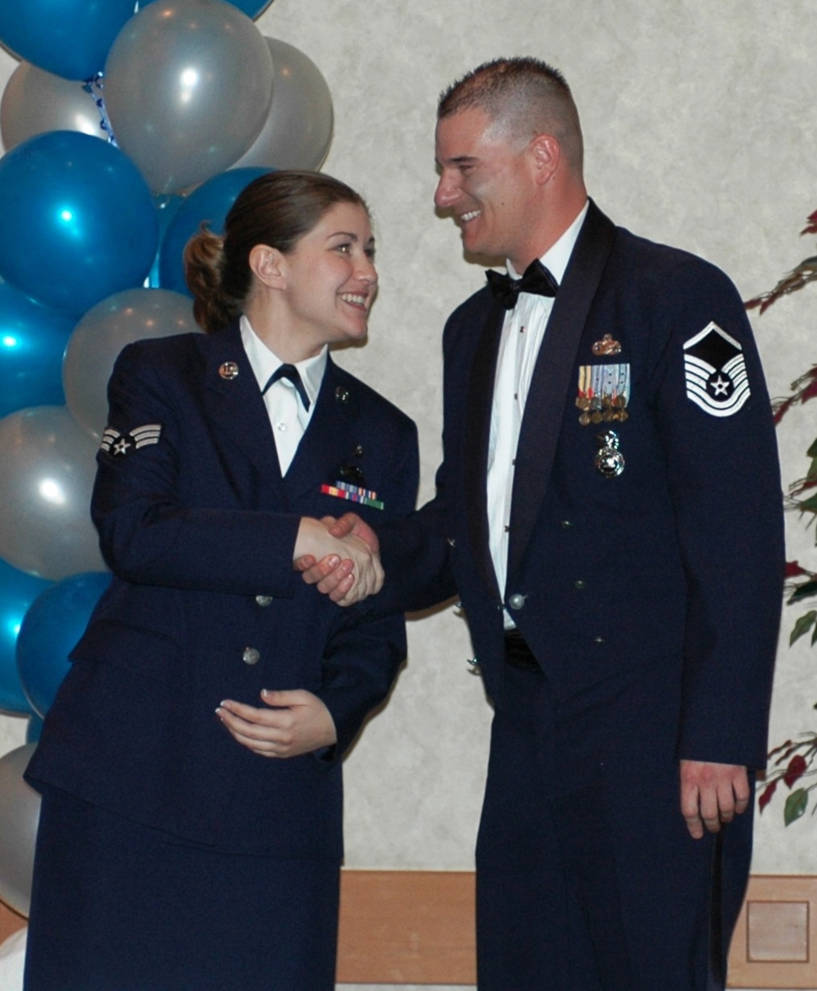 The Arizona Air National Guard Airman of the Year award winner, Senior Airman Jamie Hawkins, congratulates fellow award winner Master Sgt. Brian Thomas, Noncommissioned Officer of the Year. (Photo by Tech. Sgt. Angela Walz)