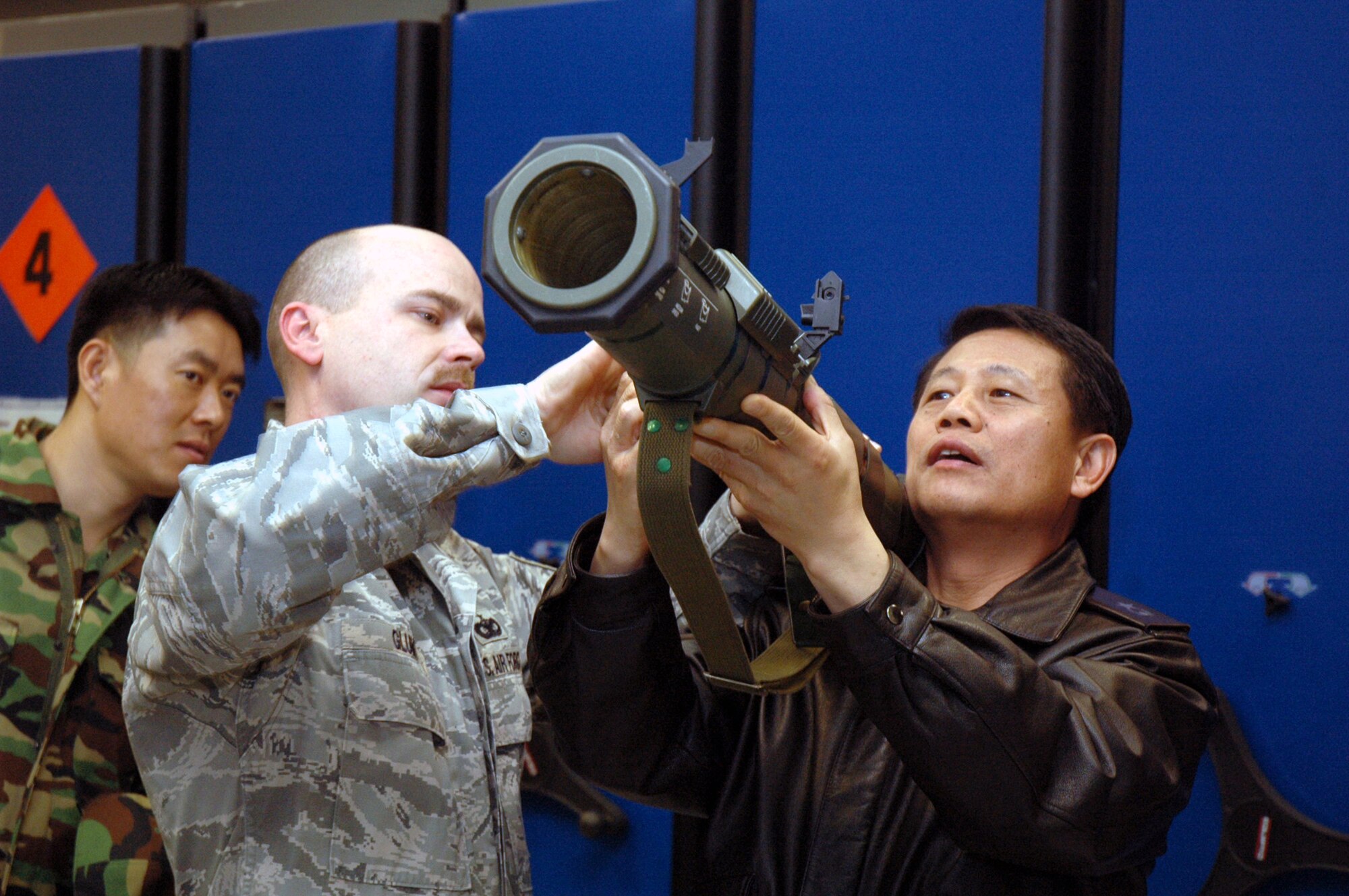 Tech. Sgt. Charles Glunt, from the U.S. Air Force Expeditionary Center's armory, shows some of the armory's weapons to Republic of Korea Brig. Gen. Young-Ki Eun, Director, Civil Engineer Division, ROK Air Force Headquarters, during General Eun's official visit March 19, 2008, on Fort Dix, N.J.  General Eun visited to learn more about the Center and the Center's operations for Air Force Exercise Eagle Flag.  The Center's armory has the Air Force's largest collection of foreign weapons on the East Coast.  (U.S. Air Force Photo/Tech. Sgt. Scott T. Sturkol) 