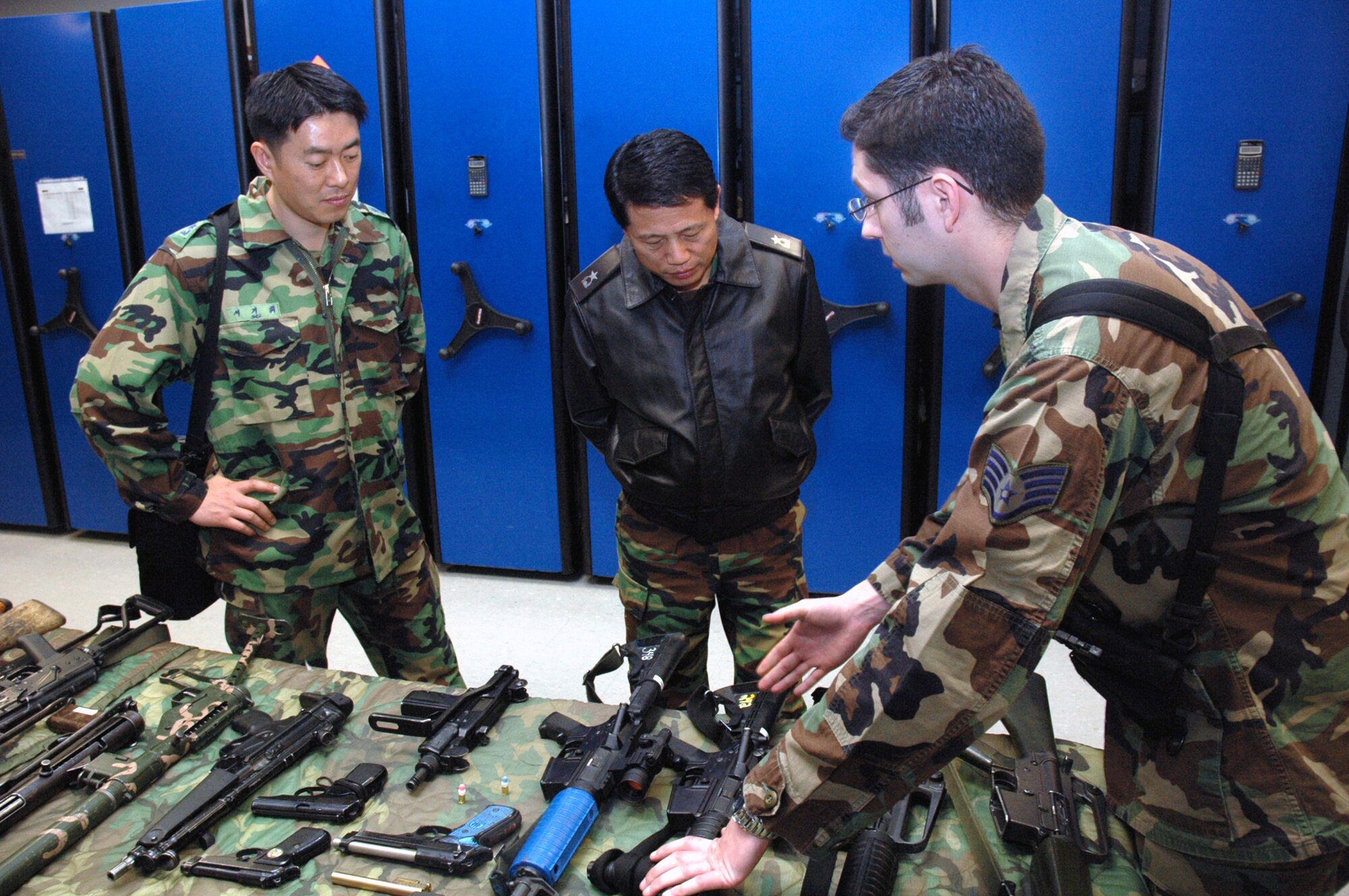 Staff Sgt. Ryan Marcotte, from the U.S. Air Force Expeditionary Center's armory, shows some of the armory's weapons to Republic of Korea Brig. Gen. Young-Ki Eun, Director, Civil Engineer Division, ROK Air Force Headquarters, and Maj. Gihwi Seo, also from the ROK air force, during General Eun's official visit March 19, 2008, on Fort Dix, N.J.  General Eun visited to learn more about the Center and the Center's operations for Air Force Exercise Eagle Flag.  The Center's armory has the Air Force's largest collection of foreign weapons on the East Coast.  (U.S. Air Force Photo/Tech. Sgt. Scott T. Sturkol) 