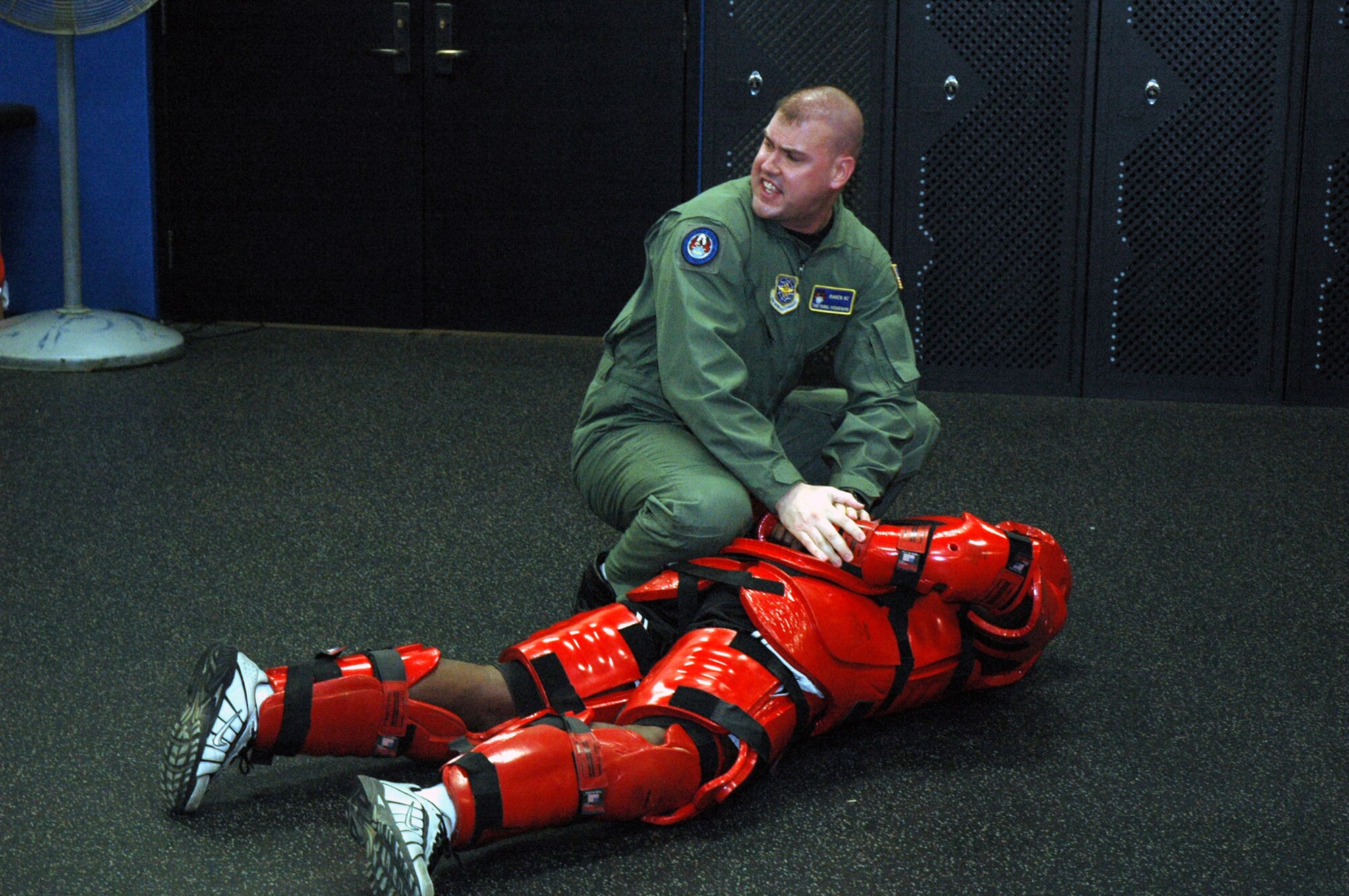 Tech. Sgt. Jeffrey Cadogan (in red man suit), Raven instructor with the U.S. Air Force Expeditionary Center's 421st Combat Training Squadron, and Tech. Sgt. Daniel Koenigsmann, also a Raven instructor, hold a Raven demonstration March 19, 2008, in the Center on Fort Dix, N.J.  In this stage of the demonstration, Sergeant Koenigsmann is using self defense to respond to an "aggressor." Phoenix Raven is a specialized course for security personnel teaching subjects such as internal and external aircraft security, self defense and weapons handling. (U.S. Air Force Photo/Tech. Sgt. Scott T. Sturkol) 