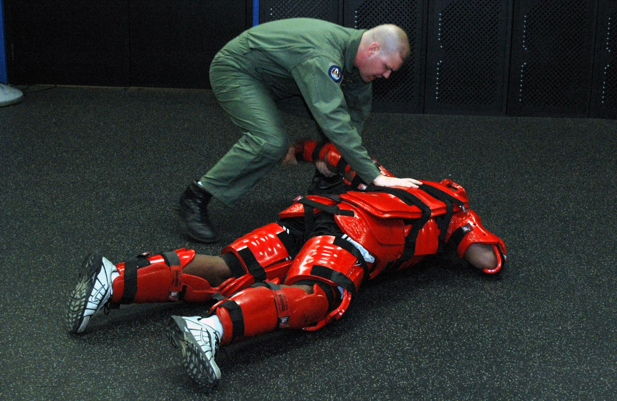 Tech. Sgt. Jeffrey Cadogan (in red man suit), Raven instructor with the U.S. Air Force Expeditionary Center's 421st Combat Training Squadron, and Tech. Sgt. Daniel Koenigsmann, also a Raven instructor, hold a Raven demonstration March 19, 2008, in the Center on Fort Dix, N.J.  In this stage of the demonstration, Sergeant Koenigsmann is using self defense to respond to an "aggressor." Phoenix Raven is a specialized course for security personnel teaching subjects such as internal and external aircraft security, self defense and weapons handling. (U.S. Air Force Photo/Tech. Sgt. Scott T. Sturkol) 