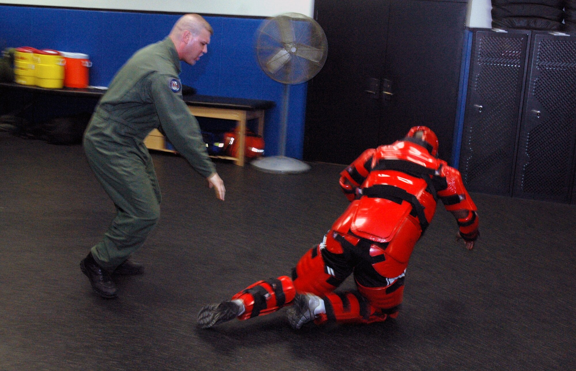 Tech. Sgt. Jeffrey Cadogan (in red man suit), Raven instructor with the U.S. Air Force Expeditionary Center's 421st Combat Training Squadron, and Tech. Sgt. Daniel Koenigsmann, also a Raven instructor, hold a Raven demonstration March 19, 2008, in the Center on Fort Dix, N.J.  In this stage of the demonstration, Sergeant Koenigsmann is using self defense to respond to an "aggressor." Phoenix Raven is a specialized course for security personnel teaching subjects such as internal and external aircraft security, self defense and weapons handling. (U.S. Air Force Photo/Tech. Sgt. Scott T. Sturkol) 