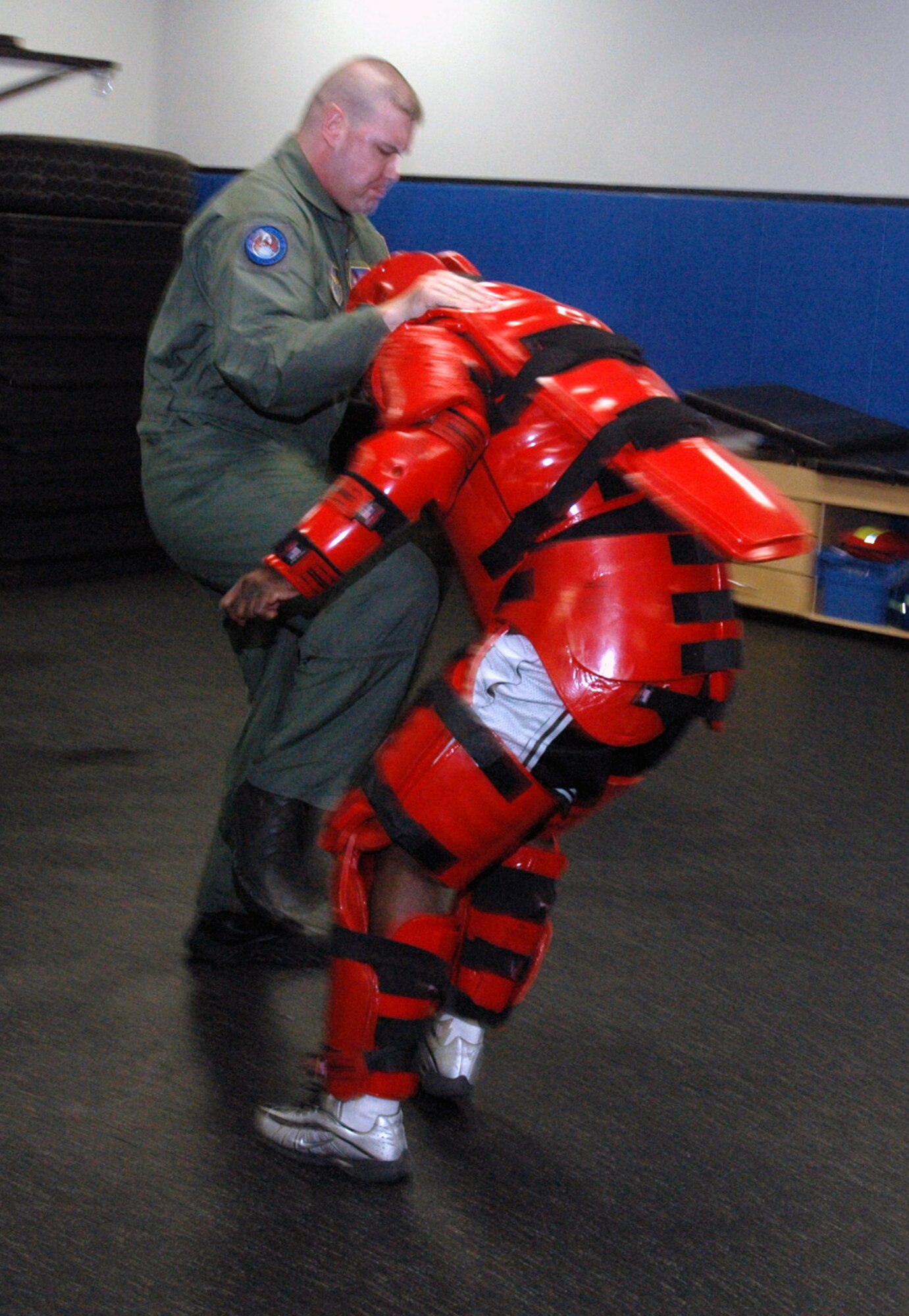 Tech. Sgt. Jeffrey Cadogan (in red man suit), Raven instructor with the U.S. Air Force Expeditionary Center's 421st Combat Training Squadron, and Tech. Sgt. Daniel Koenigsmann, also a Raven instructor, hold a Raven demonstration March 19, 2008, in the Center on Fort Dix, N.J.  In this stage of the demonstration, Sergeant Koenigsmann is using self defense to respond to an "aggressor." Phoenix Raven is a specialized course for security personnel teaching subjects such as internal and external aircraft security, self defense and weapons handling. (U.S. Air Force Photo/Tech. Sgt. Scott T. Sturkol) 