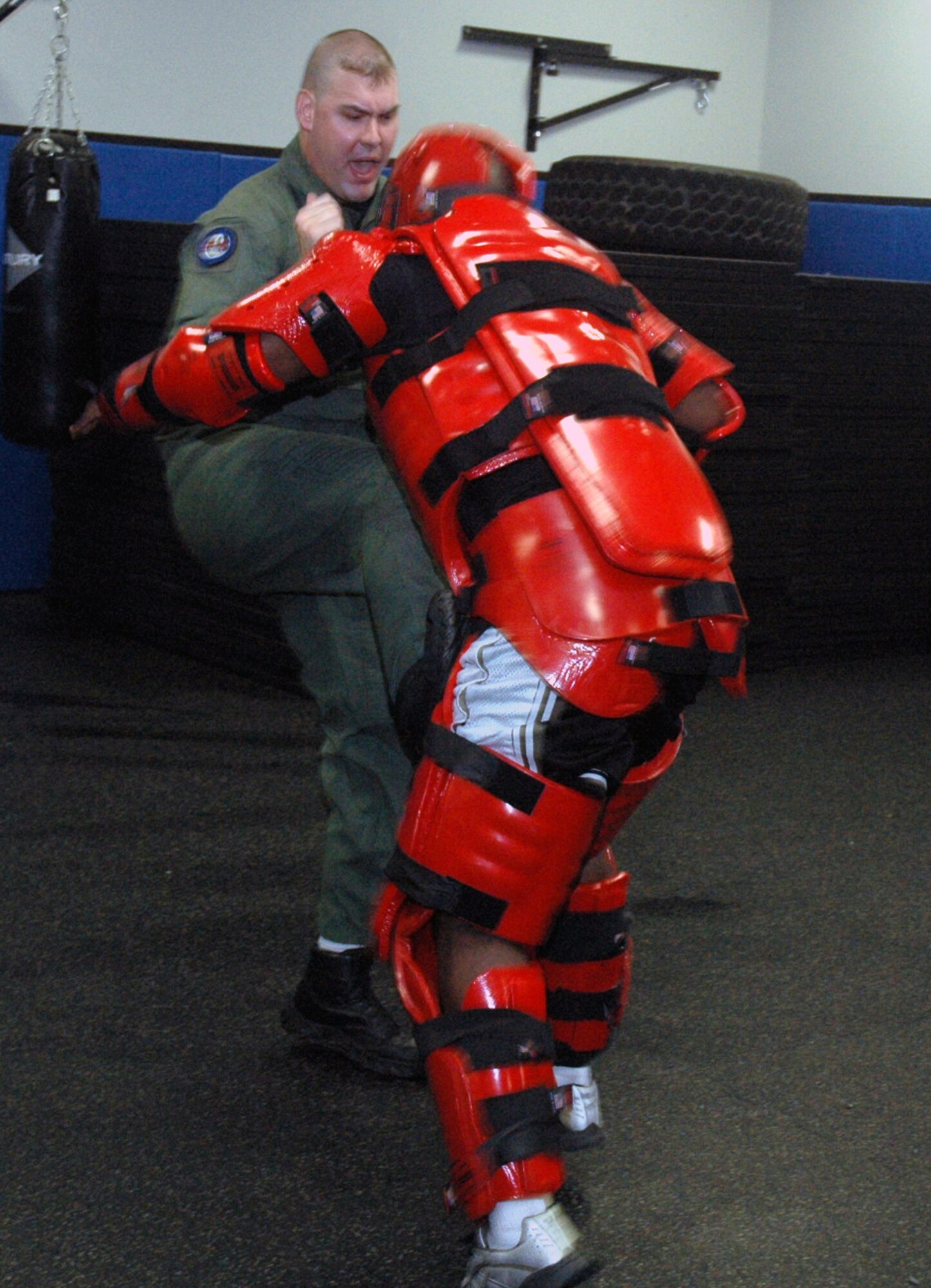 Tech. Sgt. Jeffrey Cadogan (in red man suit), Raven instructor with the U.S. Air Force Expeditionary Center's 421st Combat Training Squadron, and Tech. Sgt. Daniel Koenigsmann, also a Raven instructor, hold a Raven demonstration March 19, 2008, in the Center on Fort Dix, N.J.  In this stage of the demonstration, Sergeant Koenigsmann is using self defense to respond to an "aggressor." Phoenix Raven is a specialized course for security personnel teaching subjects such as internal and external aircraft security, self defense and weapons handling. (U.S. Air Force Photo/Tech. Sgt. Scott T. Sturkol) 