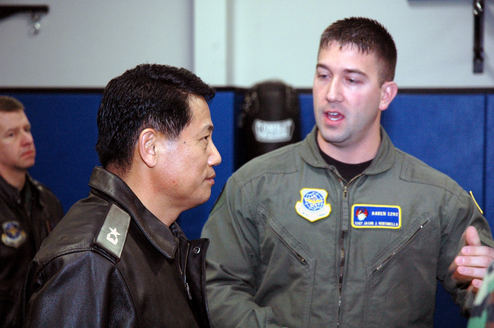 Staff Sgt. Jason Venturella, Raven instructor with the U.S. Air Force Expeditionary Center's 421st Combat Training Squadron, describes Raven training to Republic of Korea Brig. Gen. Young-Ki Eun, Director, Civil Engineer Division, ROK Air Force Headquarters, and Maj. Gihwi Seo, also from the ROK air force, during General Eun's official visit March 19, 2008, on Fort Dix, N.J.  General Eun visited to learn more about the Center and the Center's operations for Air Force Exercise Eagle Flag.  (U.S. Air Force Photo/Tech. Sgt. Scott T. Sturkol) 