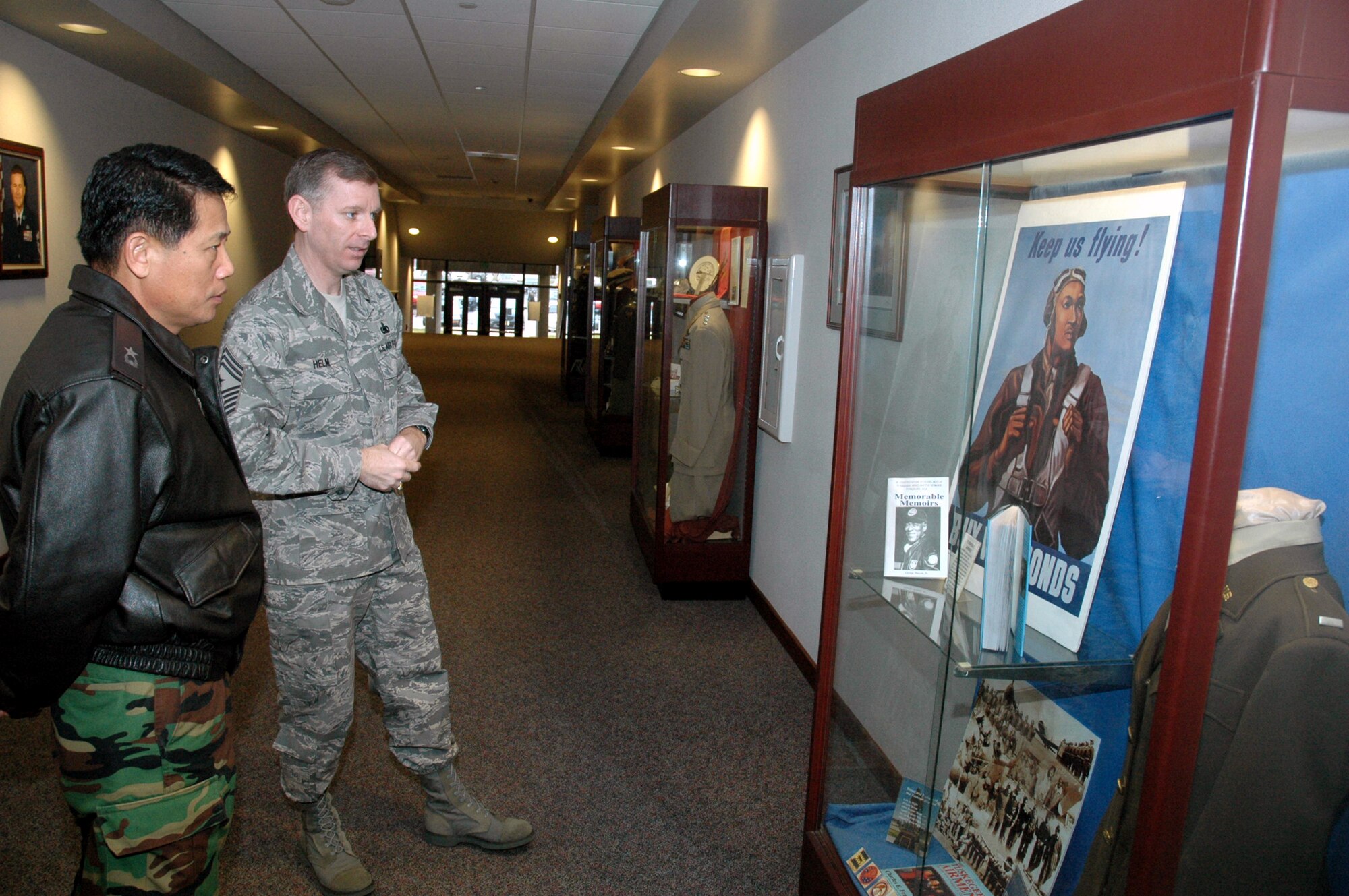 Chief Master Sgt. Jeffry Helm, U.S. Air Force Expeditionary center command chief, shows Republic of Korea Brig. Gen. Young-Ki Eun, Director, Civil Engineer Division, ROK Air Force Headquarters, the Tuskegee Airman display case in the Center during General Eun's official visit March 19, 2008, on Fort Dix, N.J.  General Eun visited to learn more about the Center and the Center's operations for Air Force Exercise Eagle Flag.  (U.S. Air Force Photo/Tech. Sgt. Scott T. Sturkol) 