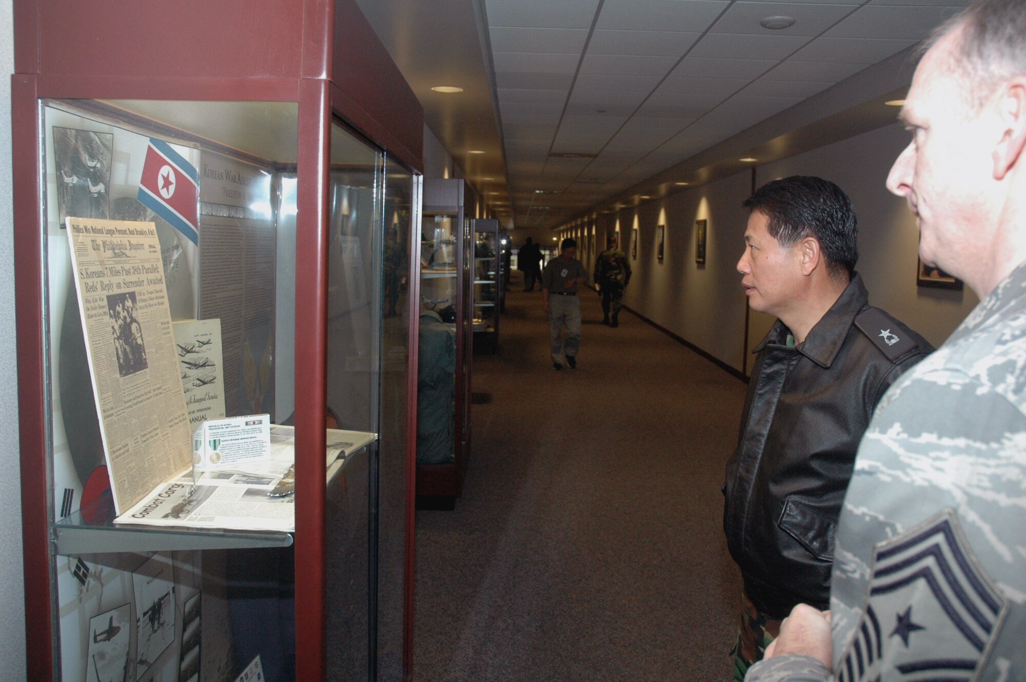 Chief Master Sgt. Jeffry Helm, U.S. Air Force Expeditionary center command chief, shows Republic of Korea Brig. Gen. Young-Ki Eun, Director, Civil Engineer Division, ROK Air Force Headquarters, the Korean War display case in the Center during General Eun's official visit March 19, 2008, on Fort Dix, N.J.  General Eun visited to learn more about the Center and the Center's operations for Air Force Exercise Eagle Flag.  (U.S. Air Force Photo/Tech. Sgt. Scott T. Sturkol) 
