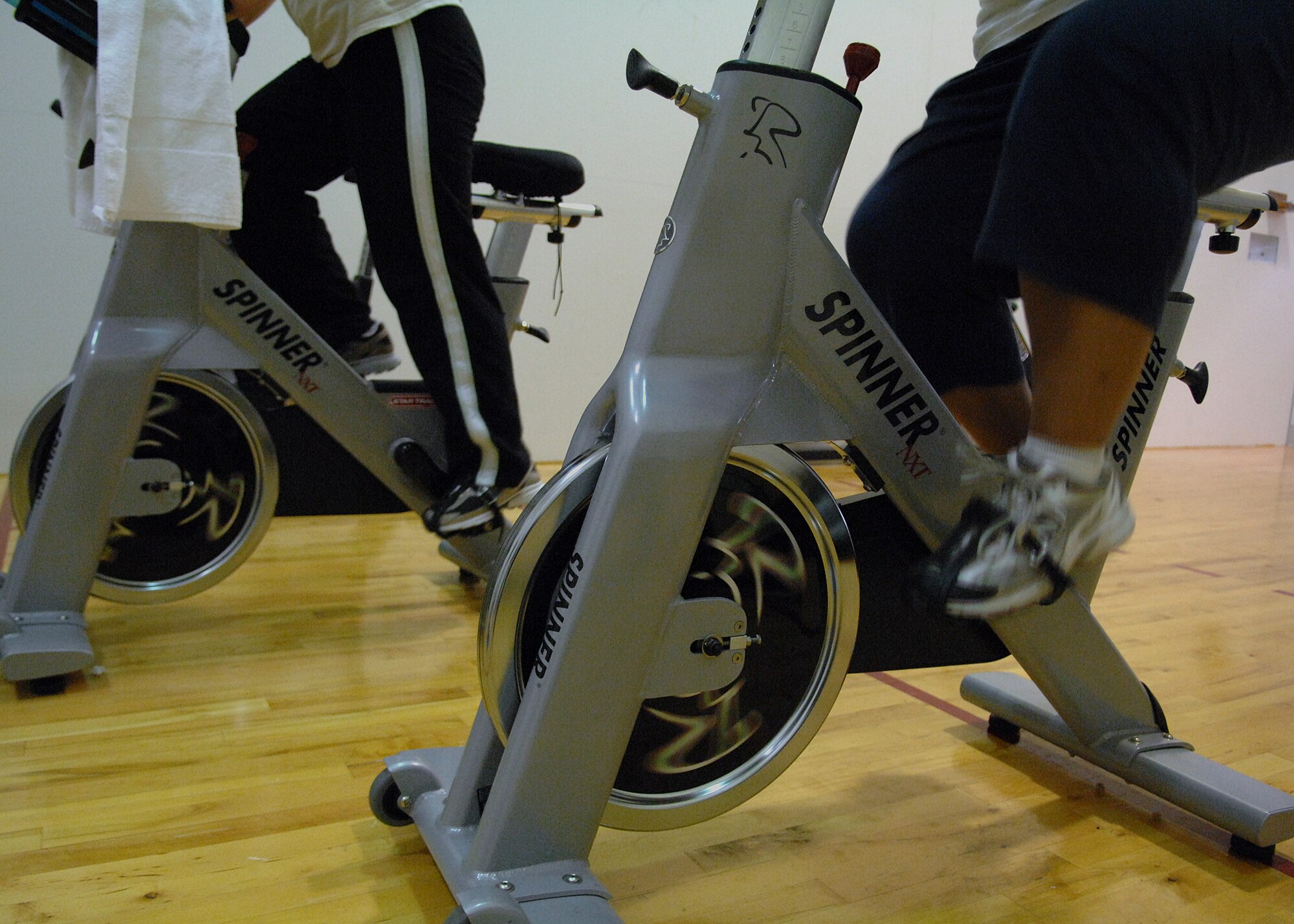 MOODY AIR FORCE BASE, Ga. -- Members of the "Phatty" team participating in Moody's Biggest Loser challenge cycle during a spinning class with their fitness trainer here March 20. Twenty-one teams are participating in the 8-week program to lose weight, get fit and eat healthy. (U.S. Air Force photo by Airman 1st Class Brittany Barker)