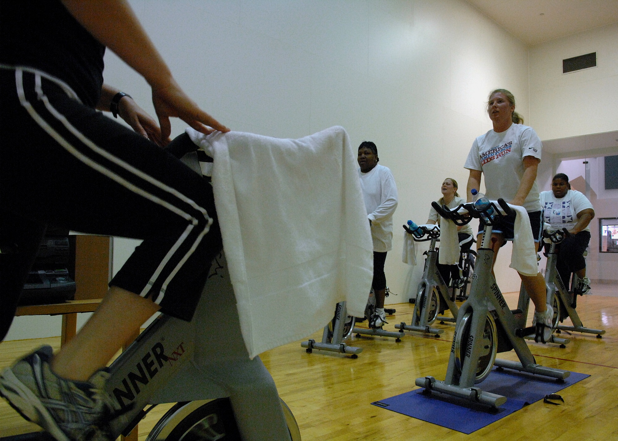 MOODY AIR FORCE BASE, Ga. -- Members of the "Phatty" team participating in the Biggest Loser challenge, work out during a cycling class with their fitness instructor, Tammy Turnmeyer, 23rd Force Support Squadron Freedom I Fitness director, here March 20. Members of Team Moody participating in the Biggest Loser challenge compete to see which team can lose the highest percentage of body fat . (U.S. Air Force photo by Airman 1st Class Brittany Barker)