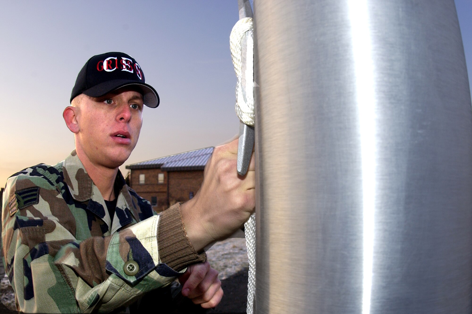 GRISSOM AIR RESERVE BASE, Ind., -- Senior Airman Matthew Crummel, 434th Civil Engineers Squadron, secures the lanyard after raising the flag on Grissom's new flag pole for the first time. The new base flag pole is located near the intersection of Grissom Avenue and Boxcar Street. (U.S. Air Force photo/Tech. Sgt. Doug Hays)